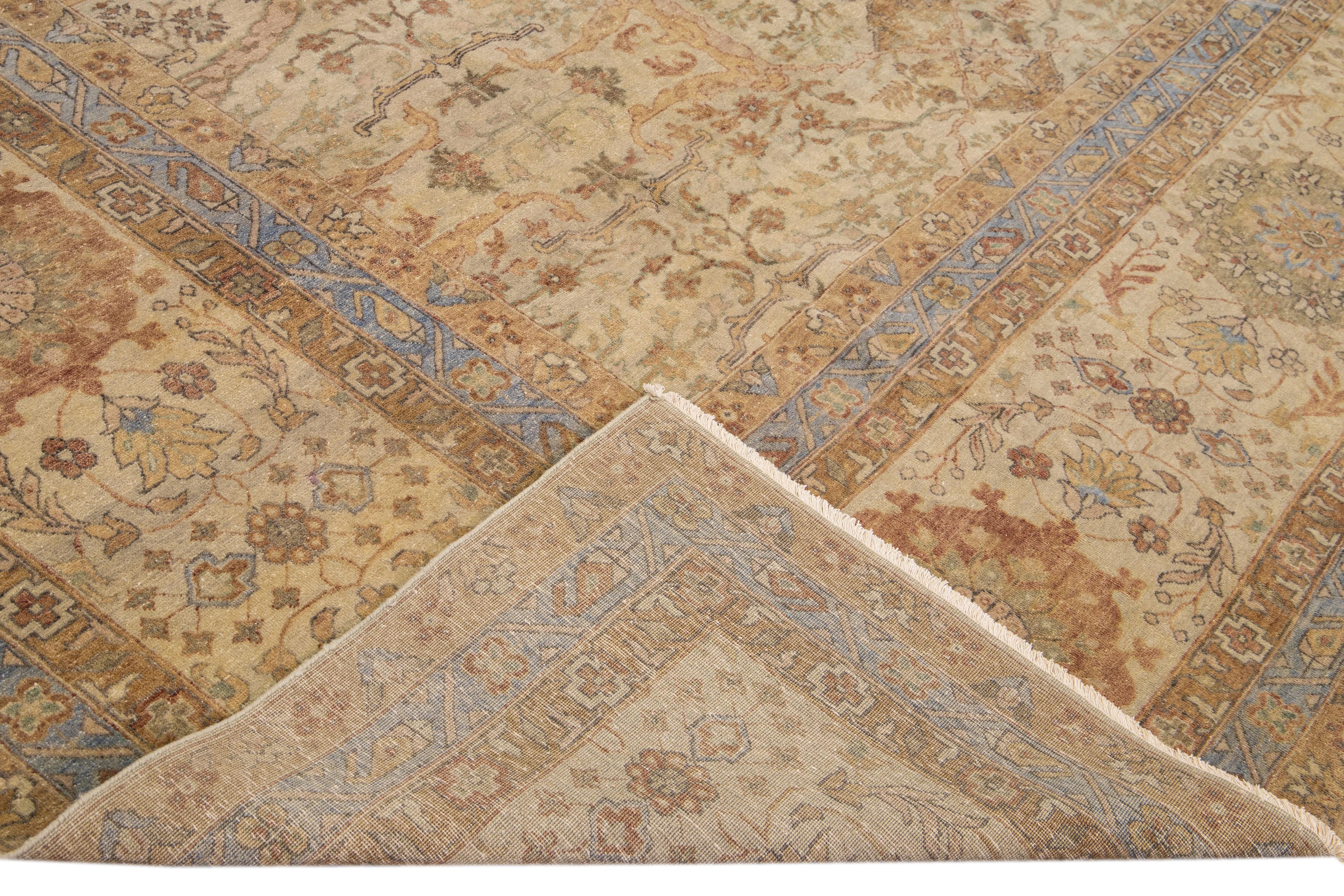 Beautiful modern Indian hand-knotted wool rug with a beige field. This modern rug has tan and blue accents gorgeous all-over geometric floral pattern design.

This rug measures: 11'8