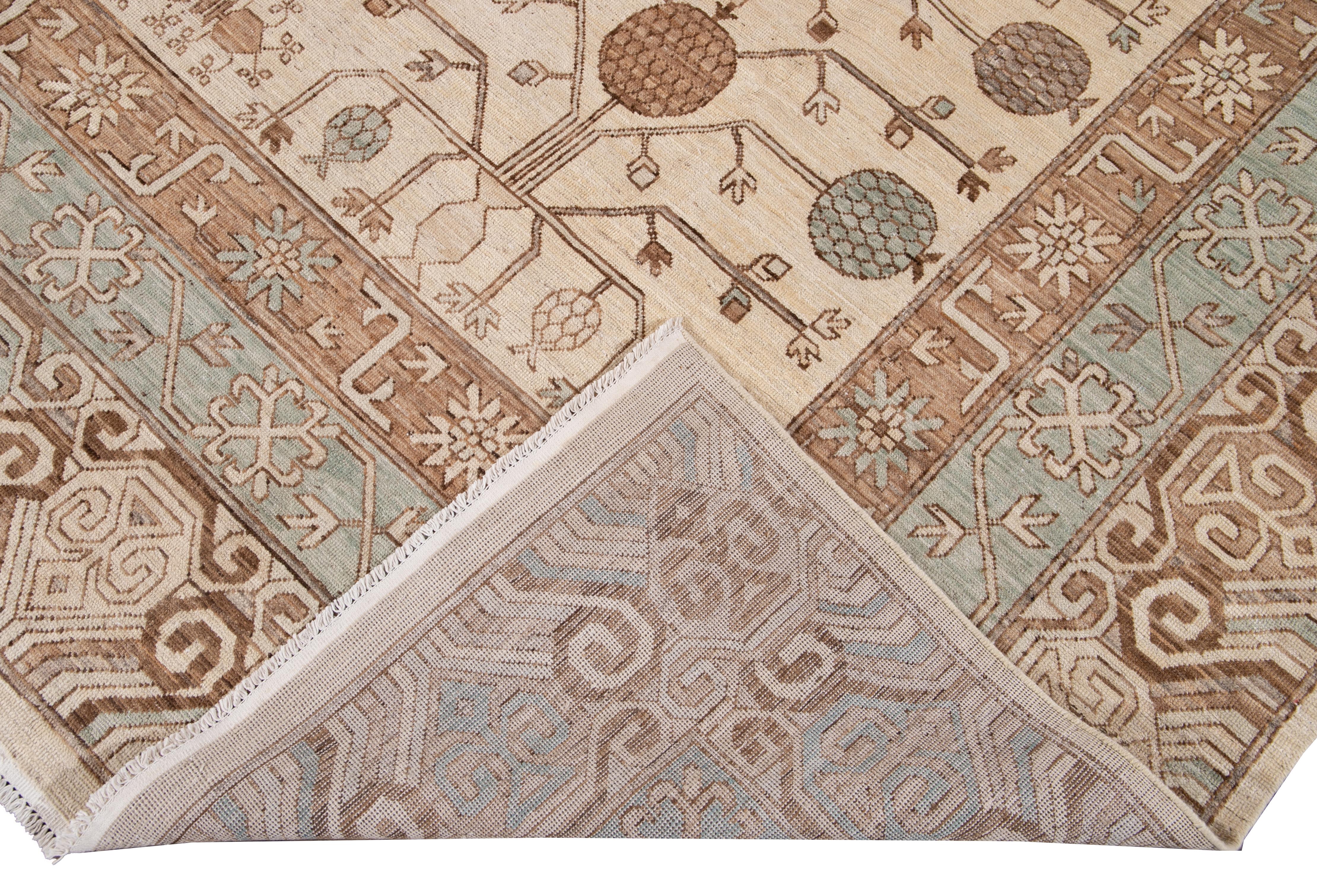 Beautiful Modern Khotan style hand knotted wool rug beige field. This Khotan-style rug has a beautifully designed frame and accent of blue, beige, and brown in a gorgeous all-over geometric floral design.

This rug measures 9' 6