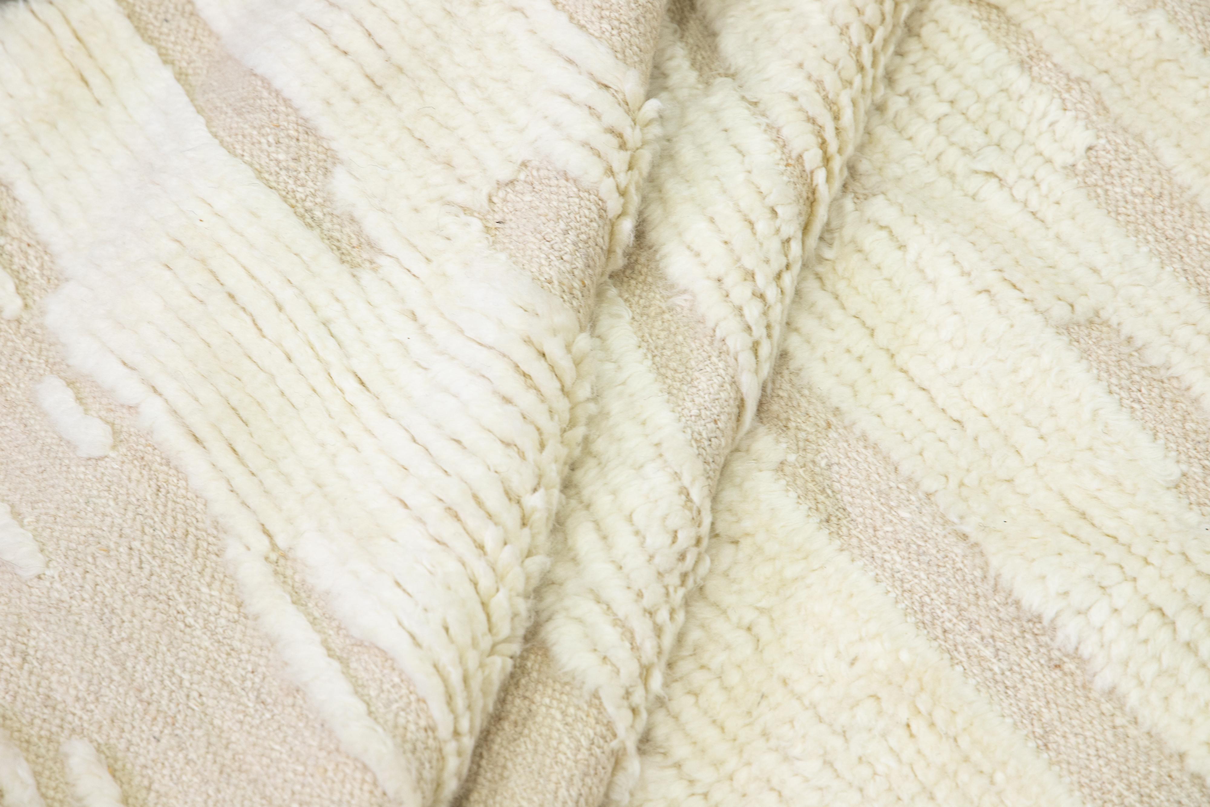 Beautiful modern Moroccan style hand-knotted wool rug with a beige color field. This Apadana's Safi Collection rug has white accents in a gorgeous all-over abstract design.

This rug measures: 11'10