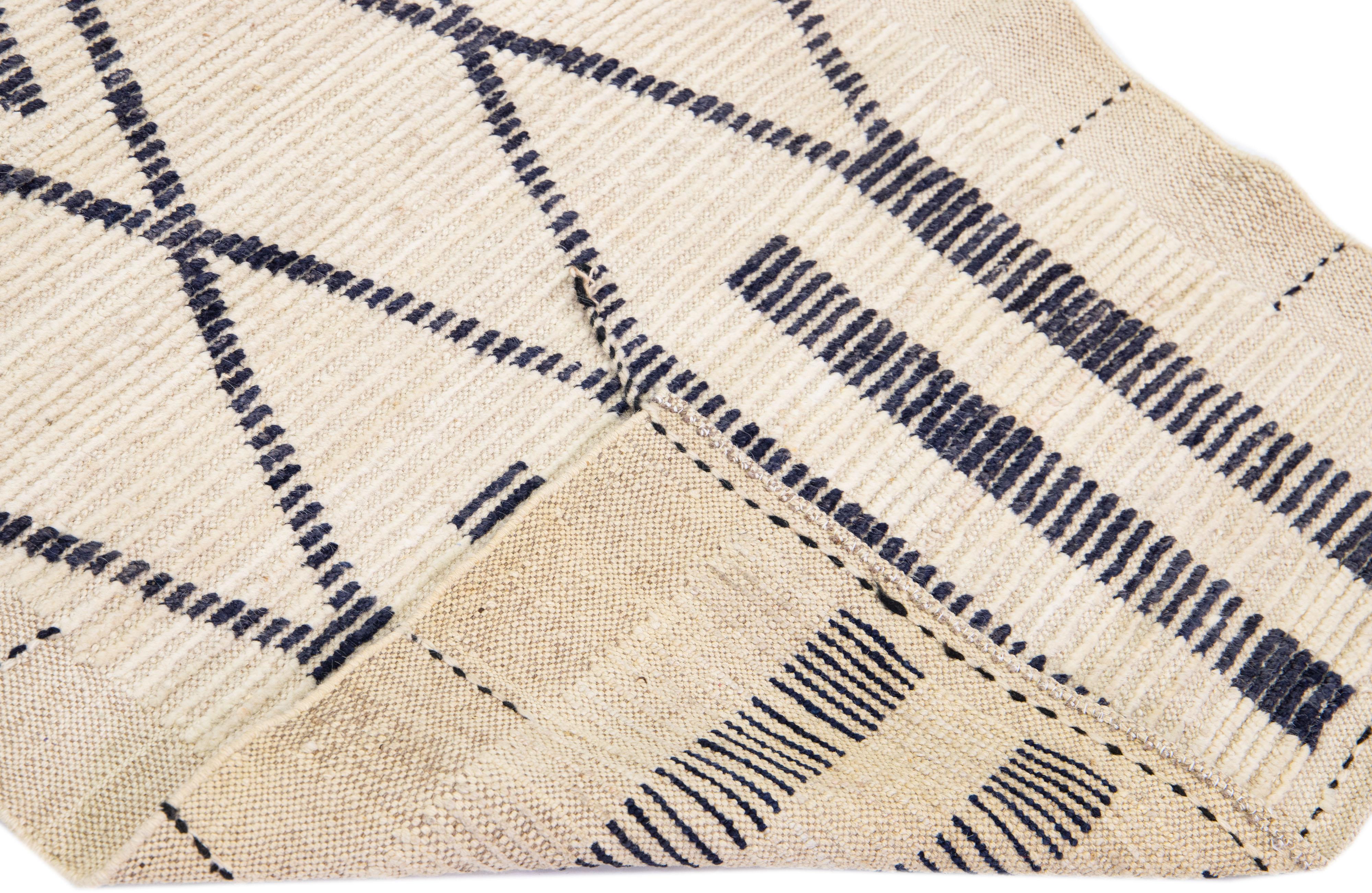 Beautiful Moroccan-style handmade wool rug with a beige field. This Modern rug has blue accents featuring a gorgeous all-over geometric tribal design.

This rug measures: 2'11