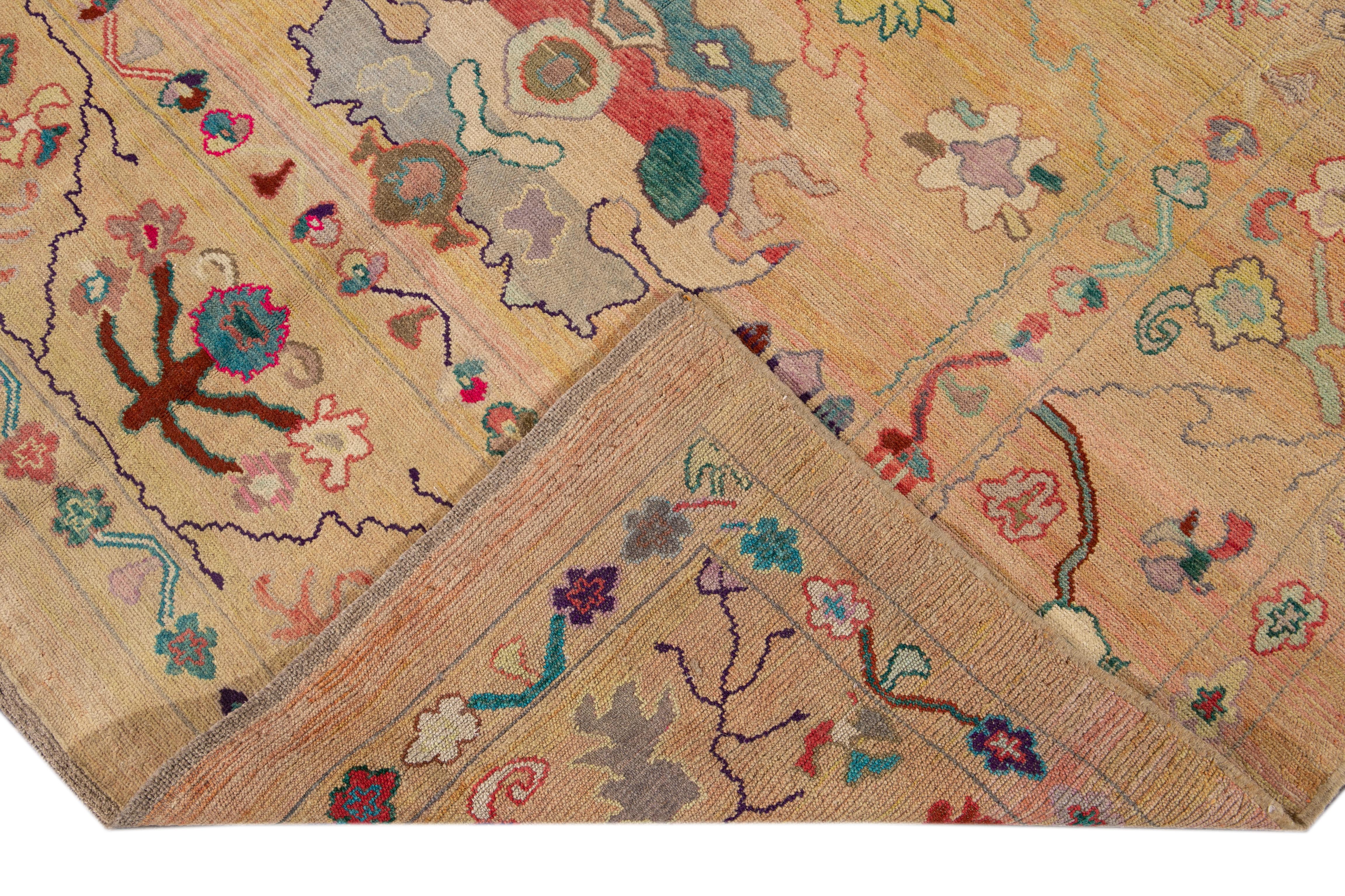 Beautiful modern hand-knotted wool rug with a peach field. This Revival Collection rug has Bright multi-color accents all-over a gorgeous geometric Floral design.

This rug measures 6'7