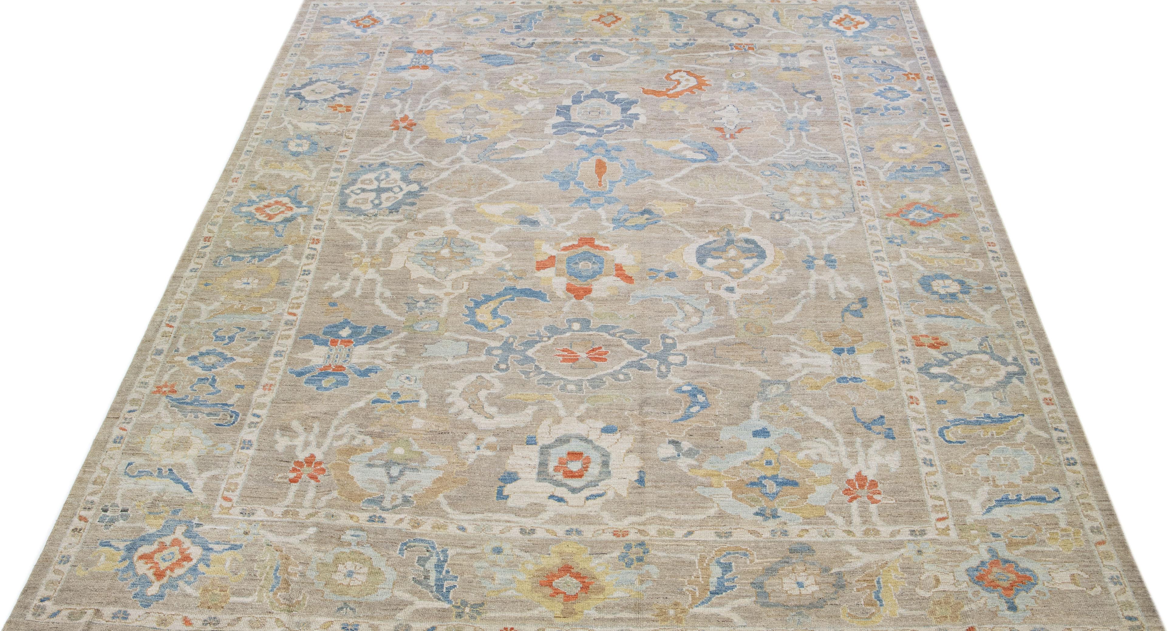 Beautiful modern Sultanabad hand knotted wool rug with a beige color field. This rug has a green-designed frame with multicolor accents in a gorgeous all-over floral design.

This rug measures: 10'5