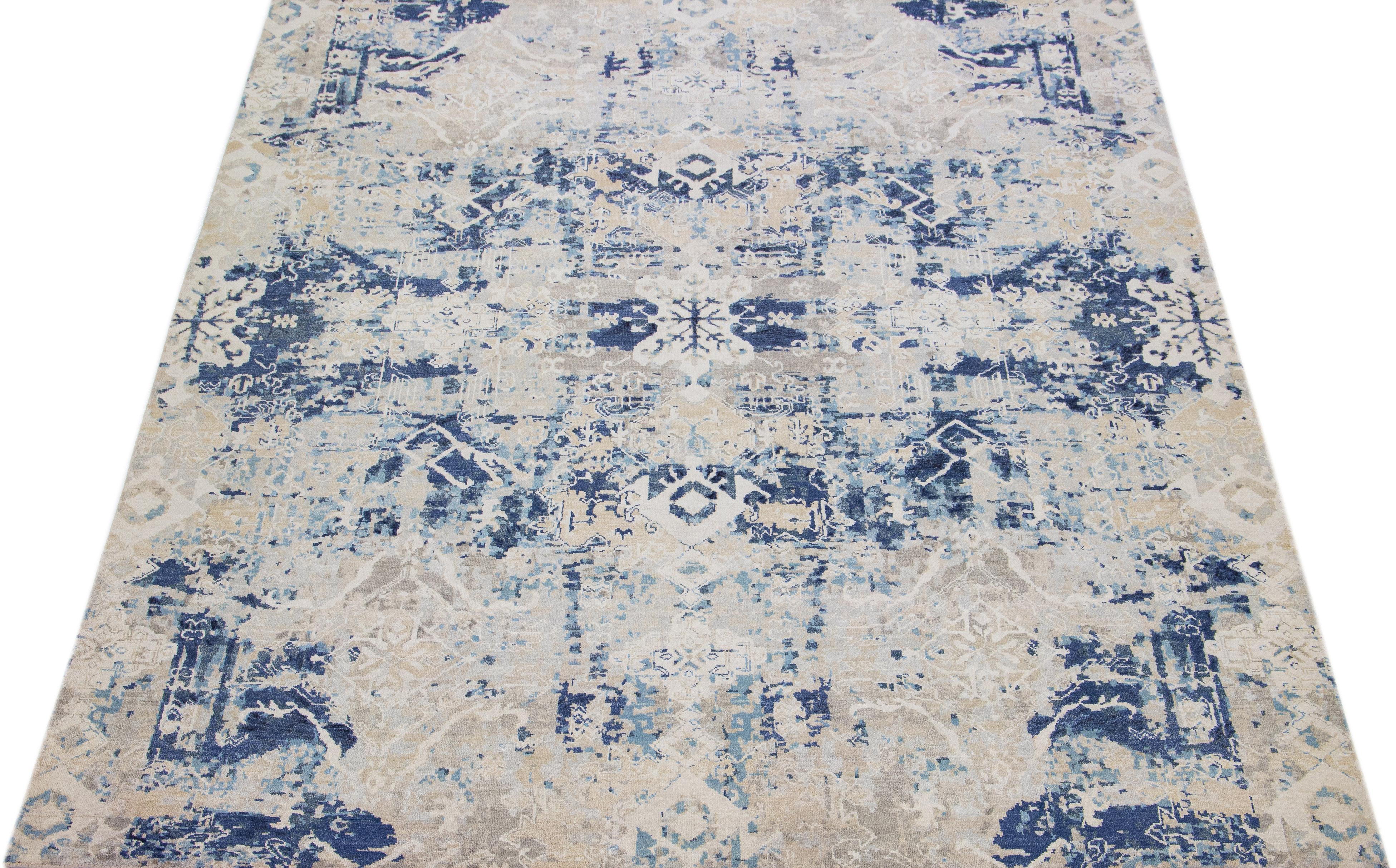 This rug features a combination of Indian wool and silk and has a beige-colored field decorated with a navy blue abstract pattern.

This rug measures 7'10