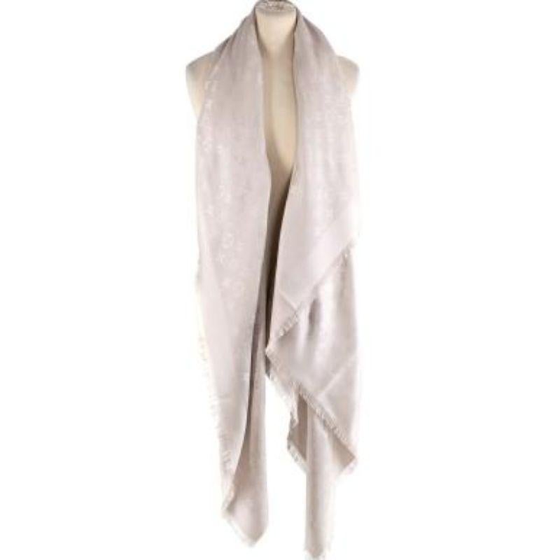 Louis Vuitton beige monogram wool-silk shawl
 
 - Silk and wool blend beige coloured shawl
 - All over iconic monogram pattern 
 - Fringed hems
 - Ribbed border
 
 Materials
 60% Silk 
 40% Wool 
 
 Made in Italy 
 Dry clean only 
 
 PLEASE NOTE,
