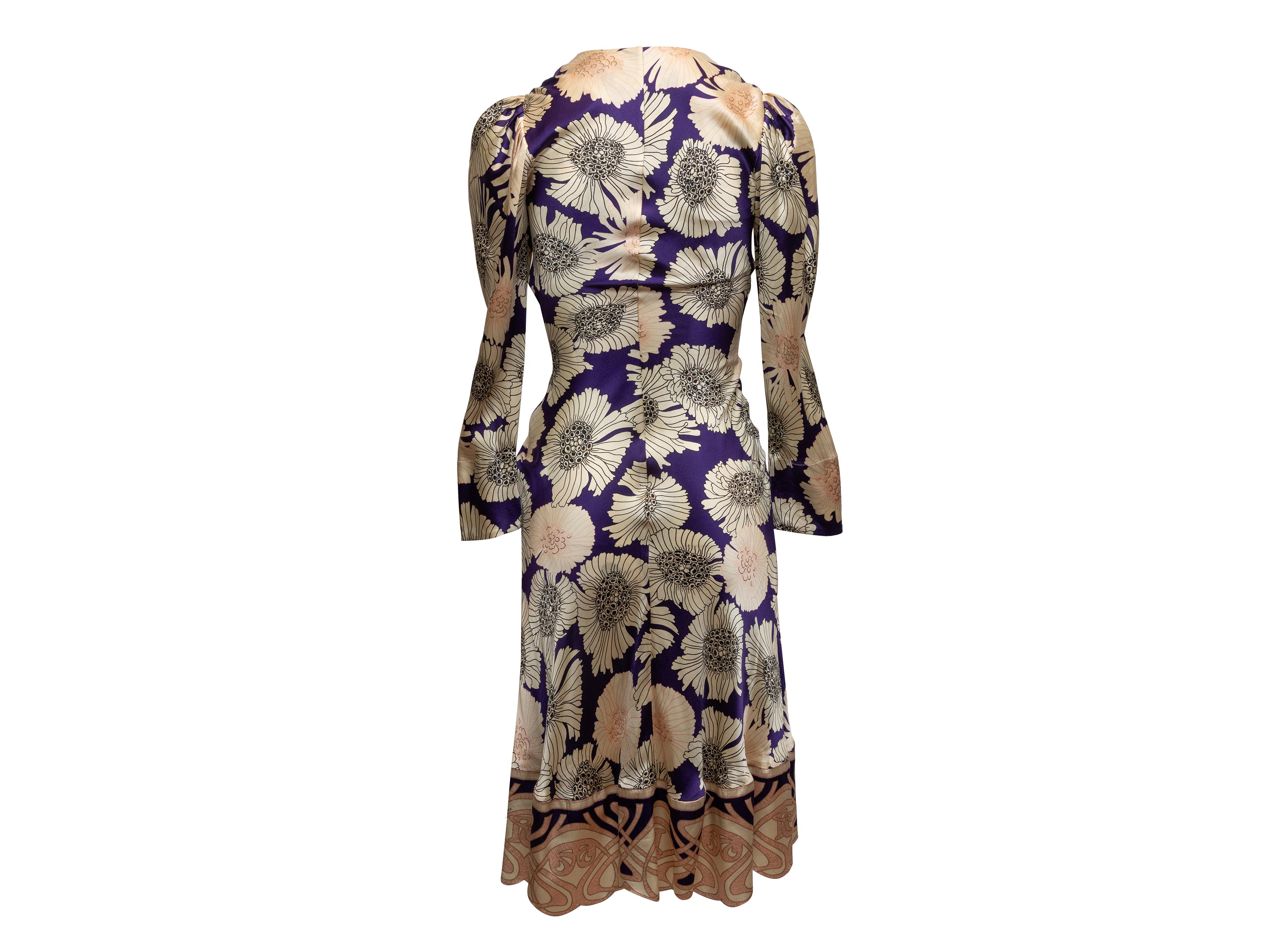 Beige and multicolor floral print silk dress by Roberto Cavalli. Surplice neckline. Gathering at waist. Long sleeves. 29