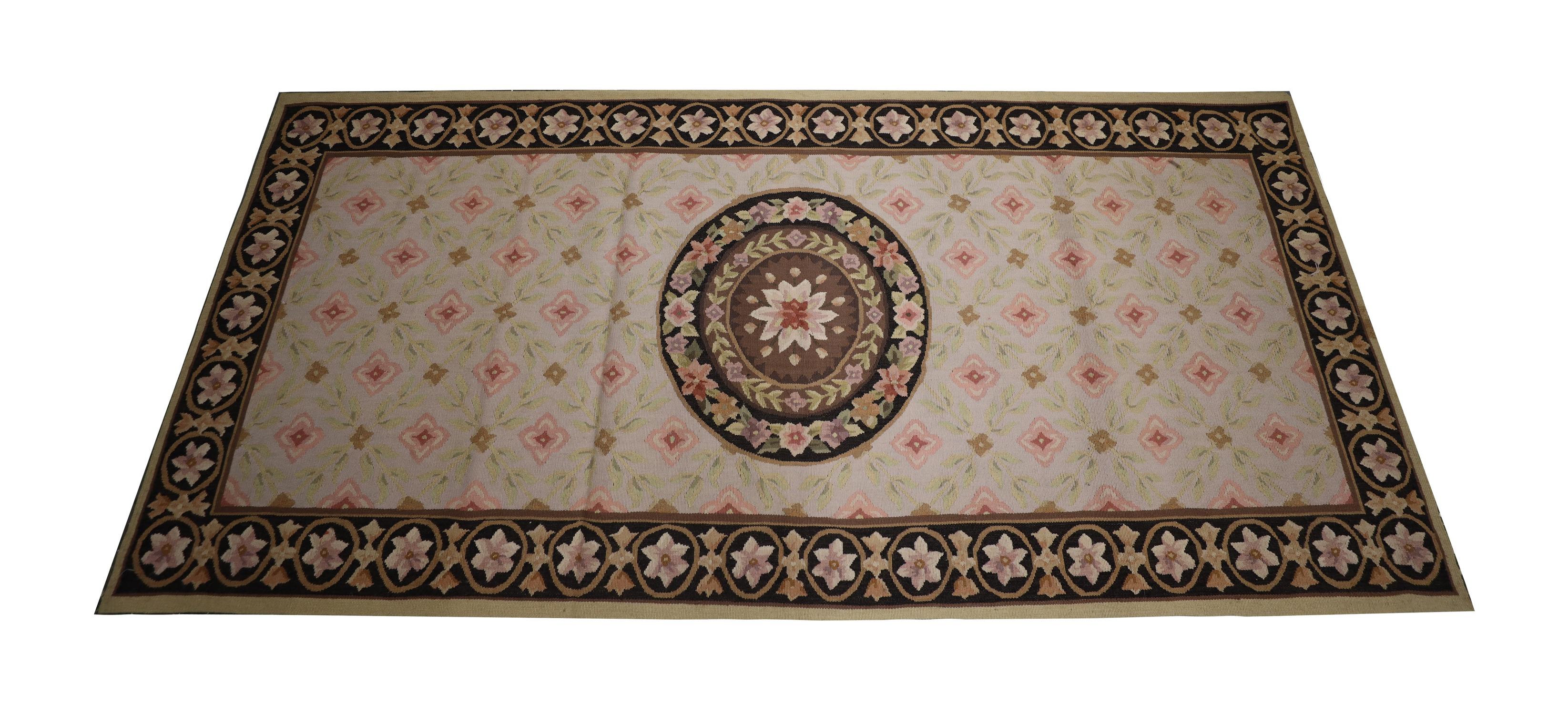 This new wool needlepoint is an elegant piece woven with an asymmetrical floral design woven with a beautiful circular floral medallion on a repeating pattern background. A bold enclosing border then frames this. The traditional design and