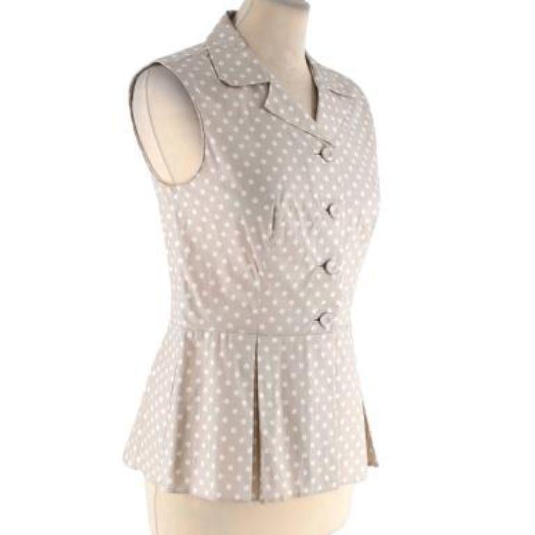 Prada Beige Polka Dot Cotton Blouse
 

 - Light beige base with an allover white polka dot
 - 1950s style silhouette with an open lapel, cinched waist, and peplum hem
 - Button front 
 - Sleeveless
 - Unlined 
 

 

 Materials 
 96% Cotton
 4%