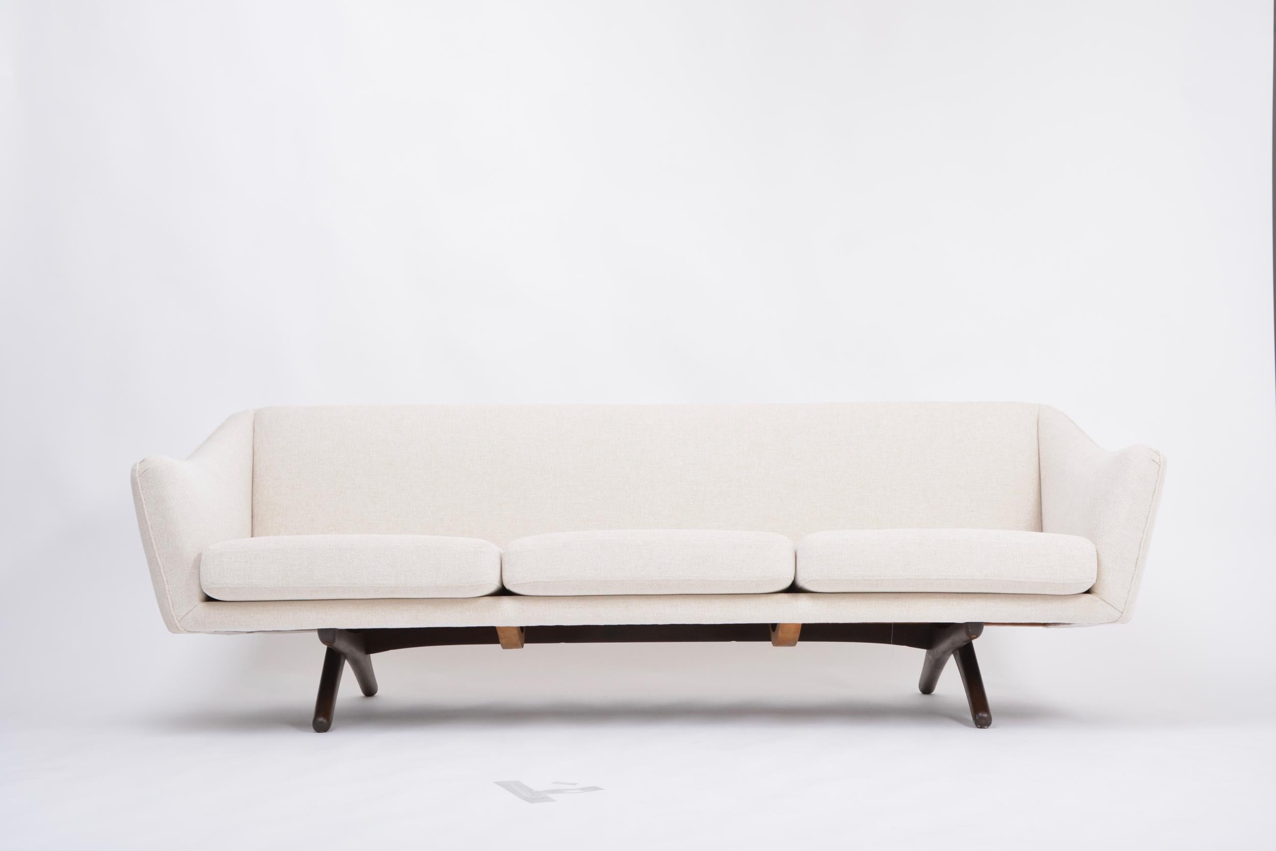 This three-seat sofa was designed by Danish designer Illum Wikkelsø and produced by Mikael Laursen in Denmark. One of the most beautiful sofa designs by Illum Wikkelso with exeptionally beautifully curved armrests and very interesting and unusually