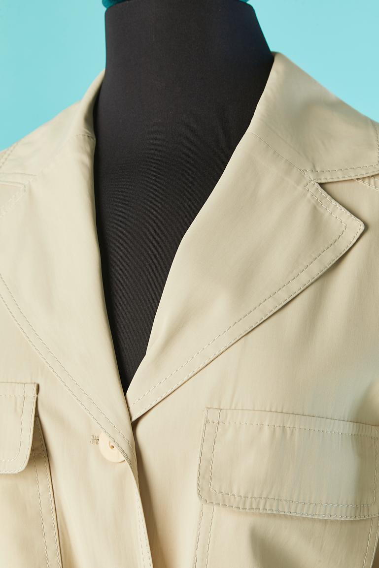 Beige Safari jacket with belt. 
Main fabric composition: 25% cotton, 68% acetate, 7% polyester. Lining in the same fabric only inside the shoulder ( back and front) and acetate lining inside the sleeve. 
Branded button.
SIZE M on tag but fit also L 