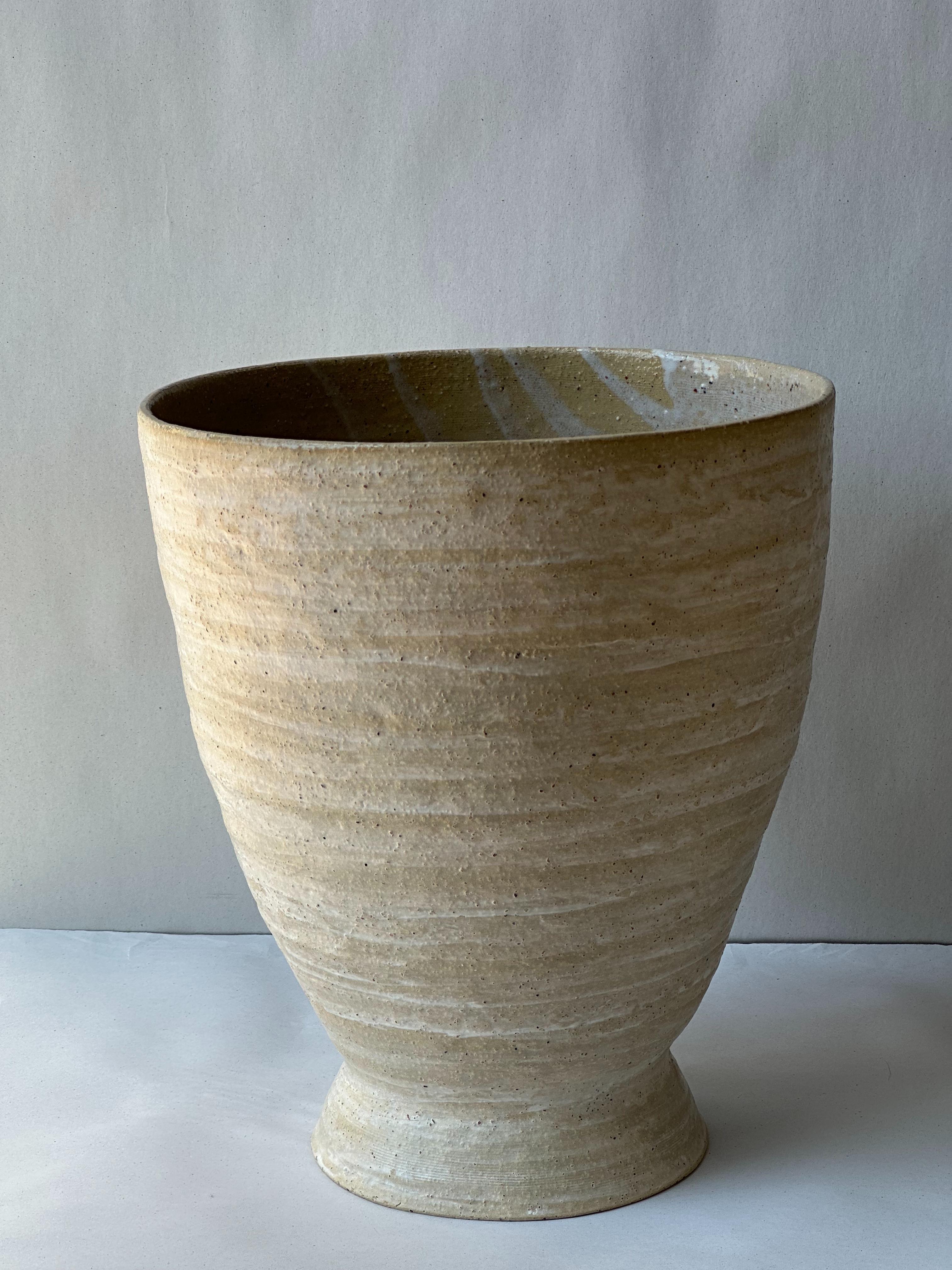 Beige Stoneware Krater Vase by Elena Vasilantonaki
Unique
Dimensions: ⌀ 25 x H 30 cm (Dimensions may vary)
Materials: Stoneware
Available finishes: Black, Beige, Brown, Red, White Patina. Interior glazed with Ash Glaze

Growing up in Greece I was