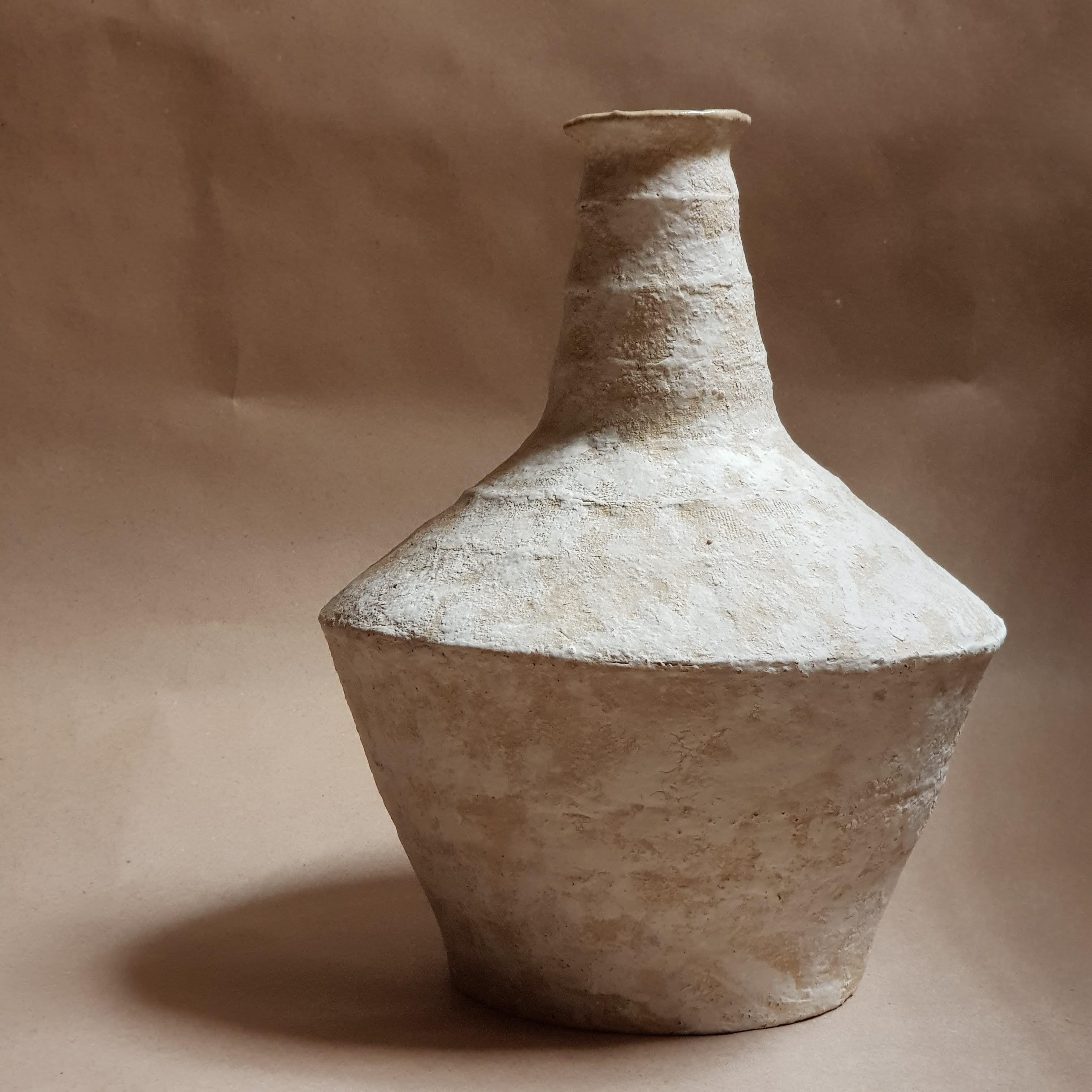 Beige Stoneware Lagynos Vase by Elena Vasilantonaki
Unique
Dimensions: ⌀ 19 x H 23 cm (Dimensions may vary)
Materials: Stoneware
Available finishes: Black, Beige, Brown, Red, Terracotta, White Patina

Growing up in Greece I was surrounded by pottery