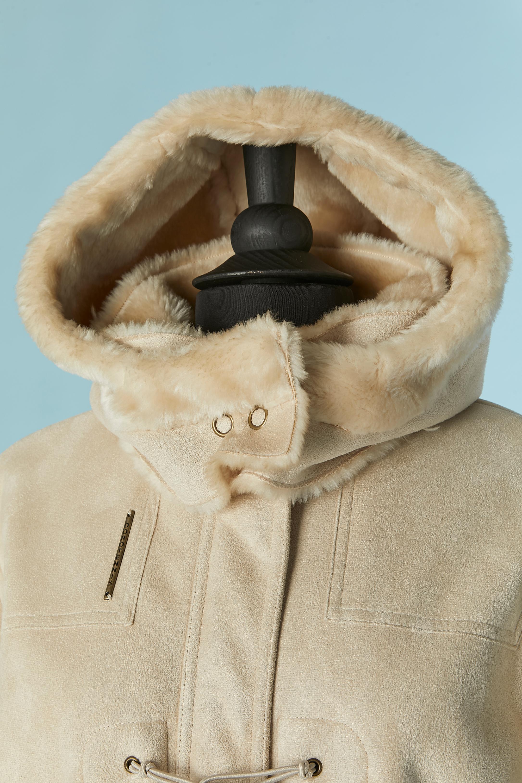 Beige Suedine duffle-coat with Faux-fur inside. Main fabric composition: 100% Polyester. Faux-fur composition: 71% acrylic, 29% polyester. 
Hidden zip closure on the middle front with button and buttonhole on the top. Detachable hood with snap.