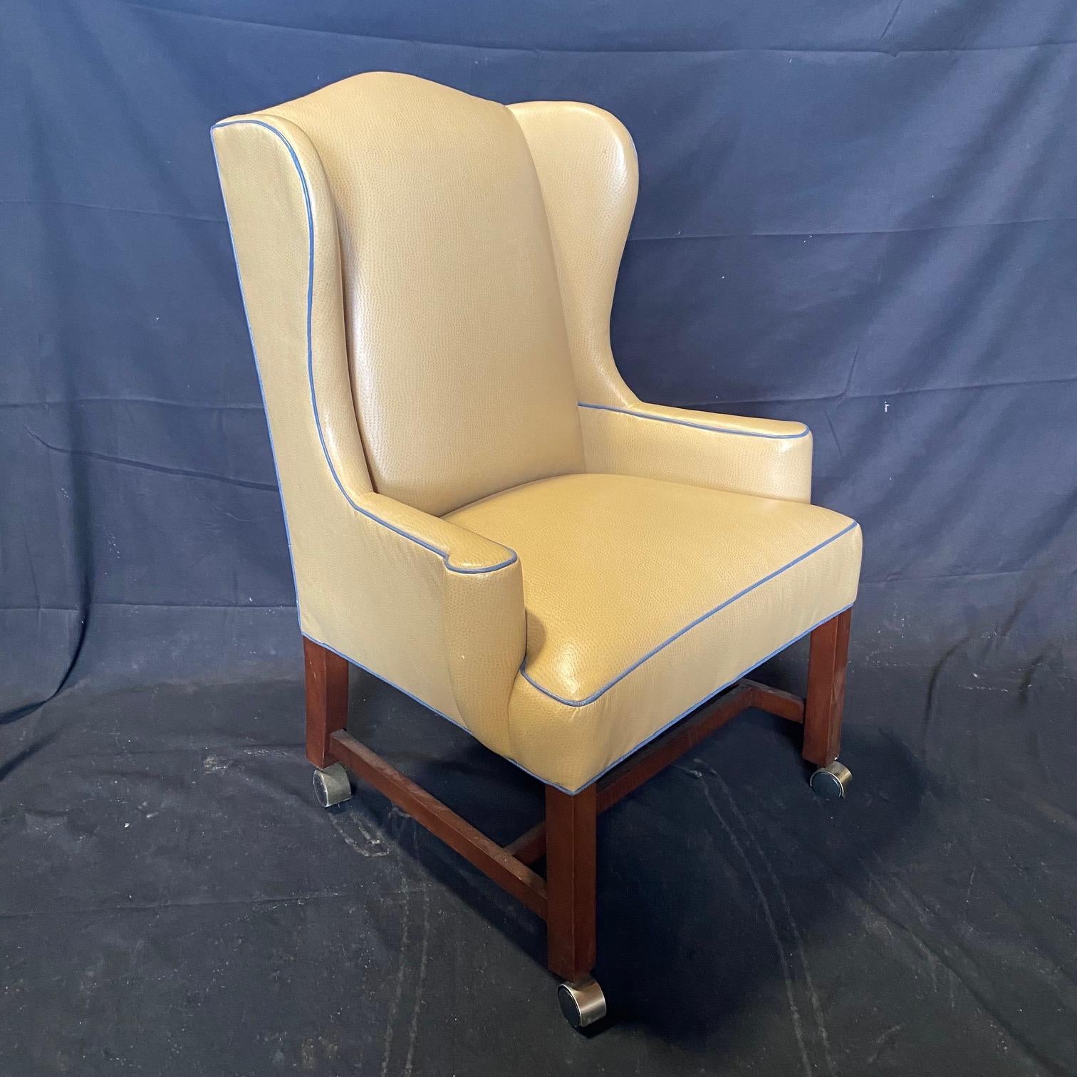  George III style beige leather wing chair of typical shape and mid sized proportions with pepper box arms set above square front legs and slightly outswept back legs. Upholstered in stunning creamy beige snakeskin imprinted leather with classic