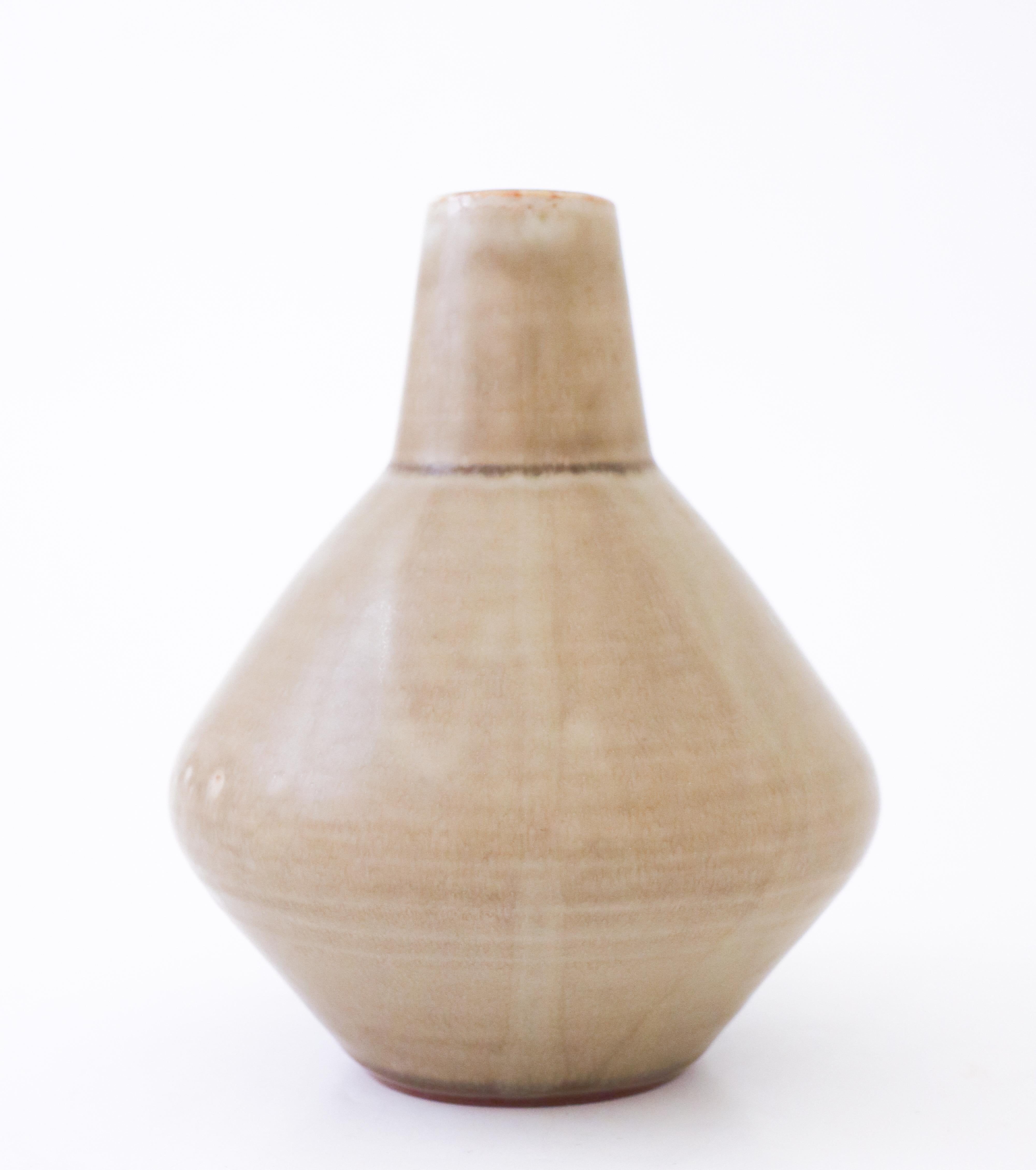A vase designed by Carl-Harry Stålhane at Rörstrand, it´s 17 cm high and it´s in very good condition except from some minor marks in the glaze from the production. It´s dated 1957 and it is a unique vase.
   