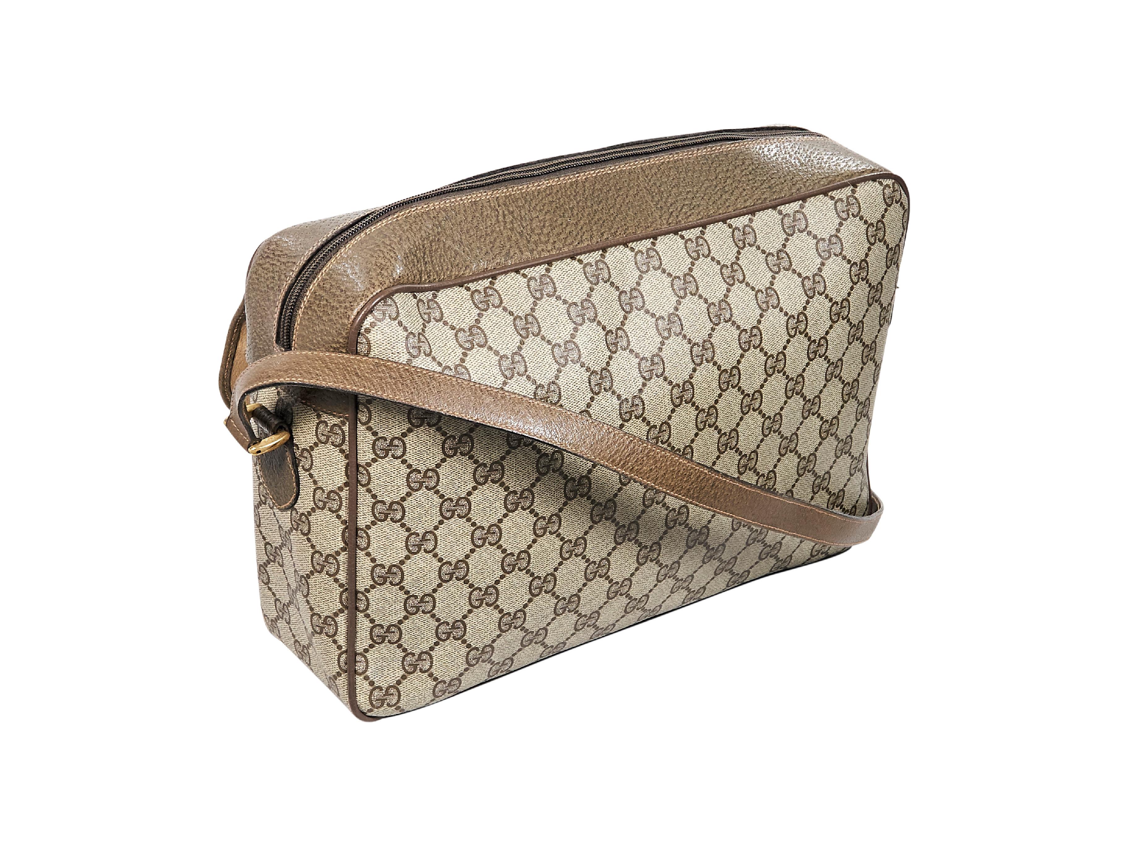 Product details:  Vintage beige logo messenger bag by Gucci.  Trimmed with leather.  Top zip closure.  Lined interior with inner zip pocket.  Front exterior flap pocket.  Goldtone hardware.  12.5