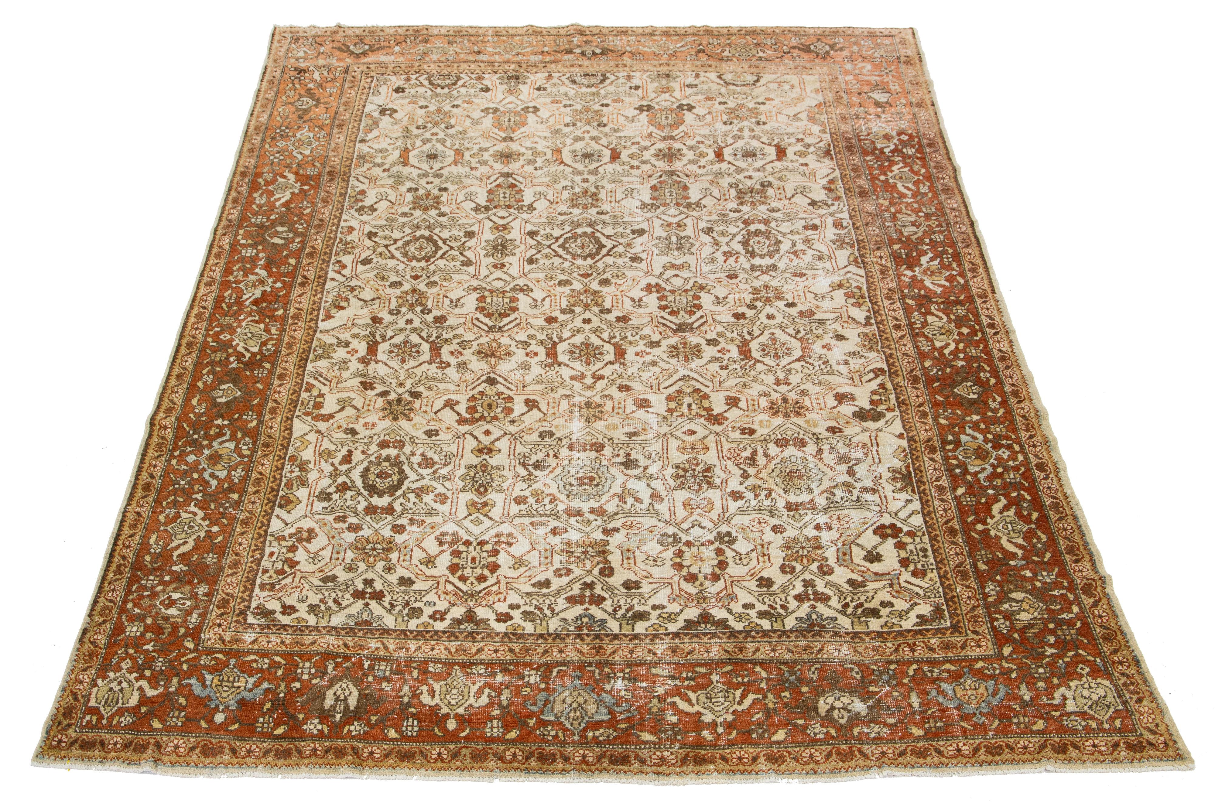 Beautiful Vintage Mahal hand-knotted wool rug with a beige color field. This Persian rug has a Classic rust and brown allover floral design.

This rug measures 8'7