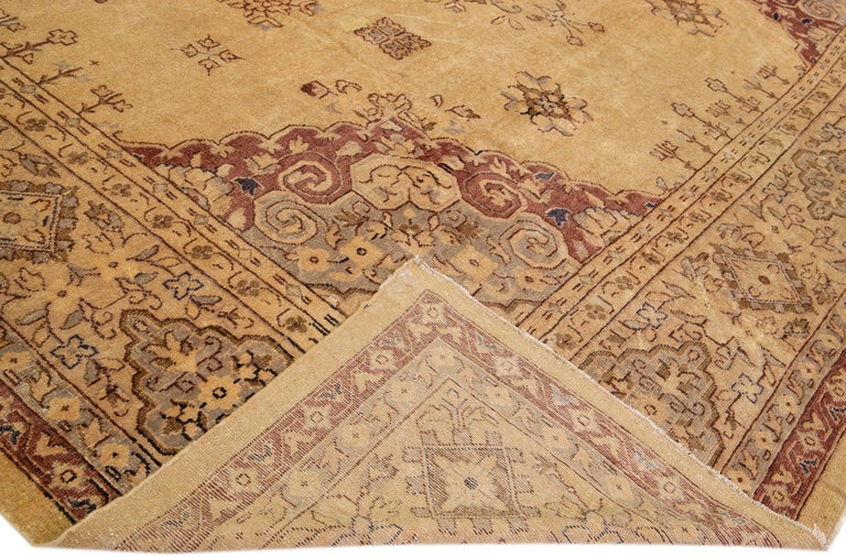 Beautiful Vintage Turkish Oushak hand-knotted wool rug with a beige field. This rug has gray and brown accents in a gorgeous large-scale floral pattern.

This rug measures: 14'8