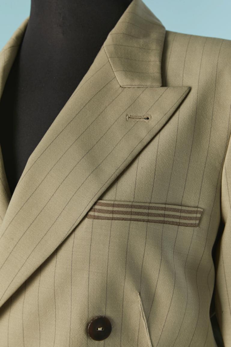 Beige wool pin-striped trouser suit with double breasted jacket. Shell composition: 100% wool. Branded Lining composition: 61% rayon, 39% acetate. 
Button and buttonhole closure on the middle front. 
Shoulder-pads. 
SIZE 42 (It) 8 (US) 