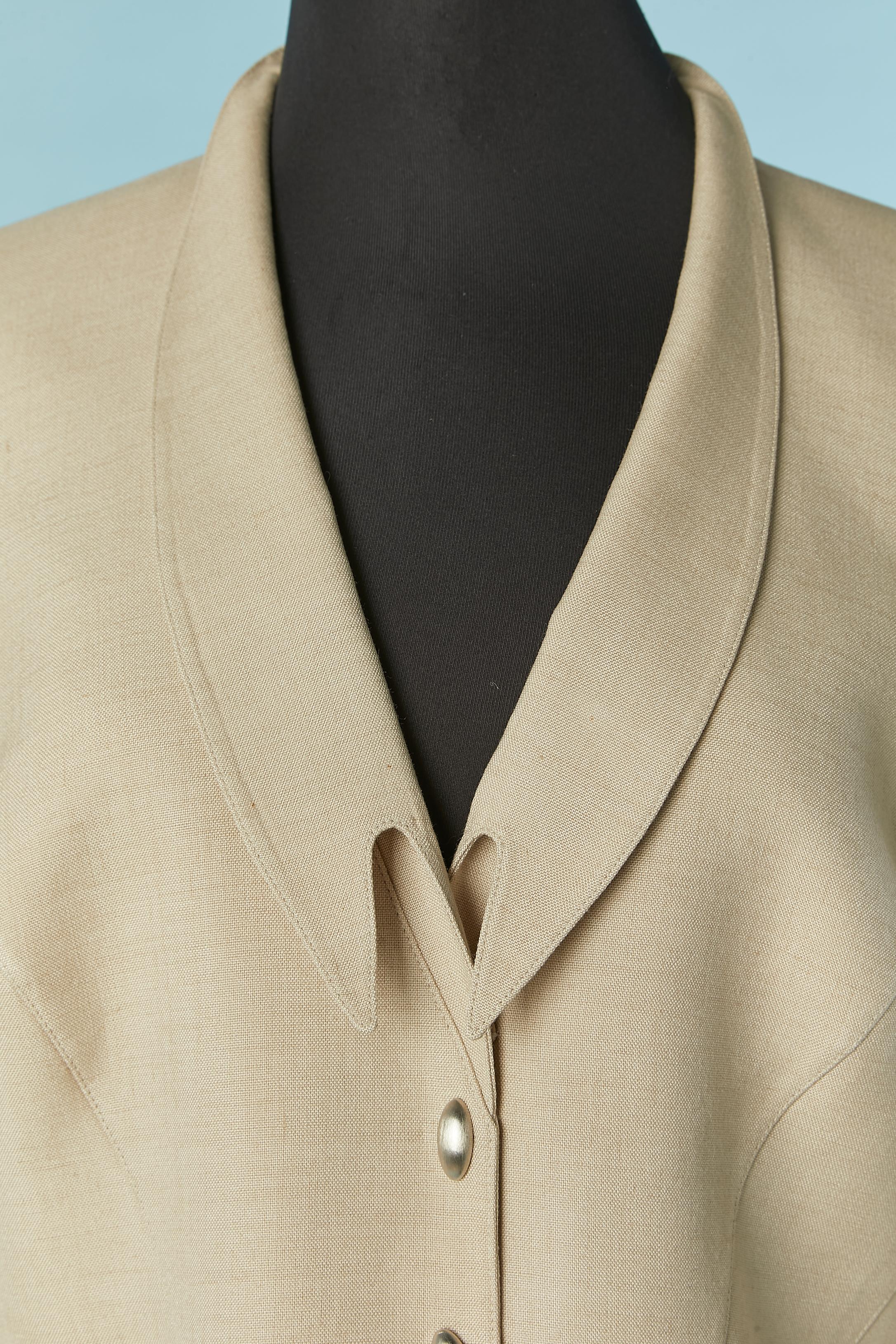 Beige wool, rayon and linen skirt-suit. 
Acetate lining. Shoulder pad. Snap closure on the middle front. Cut-work. Pockets on both side. 
SIZE 46 (Fr)  14 (US) XL 