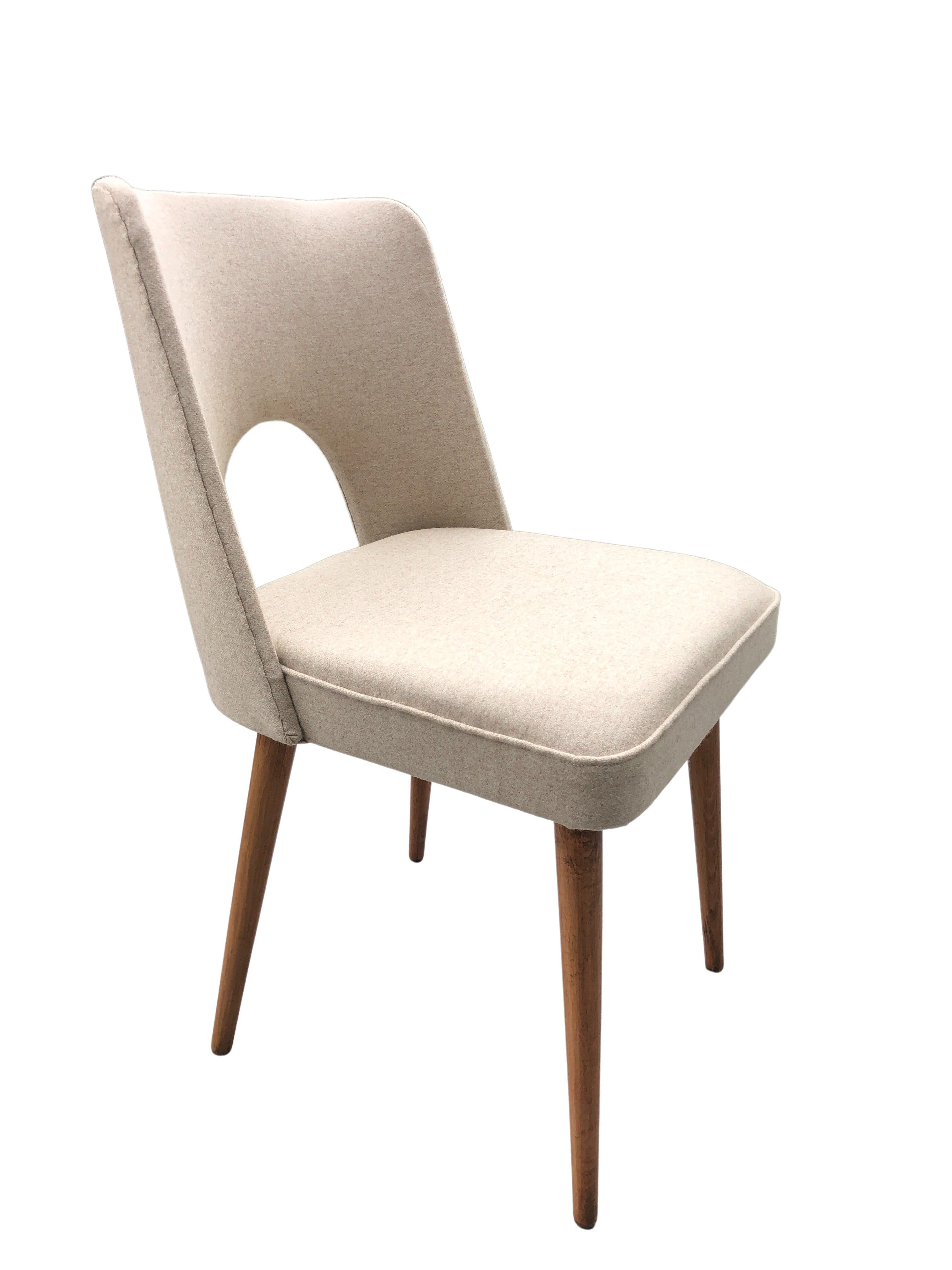 Beautiful set of 6 dining chairs with a modernist silhouette, design around 1962, manufactured by Slupskie Fabryki Mebli in Poland. The structure is made of plywood and beech wood. The upholstery is made of a high quality wool in beige color. The