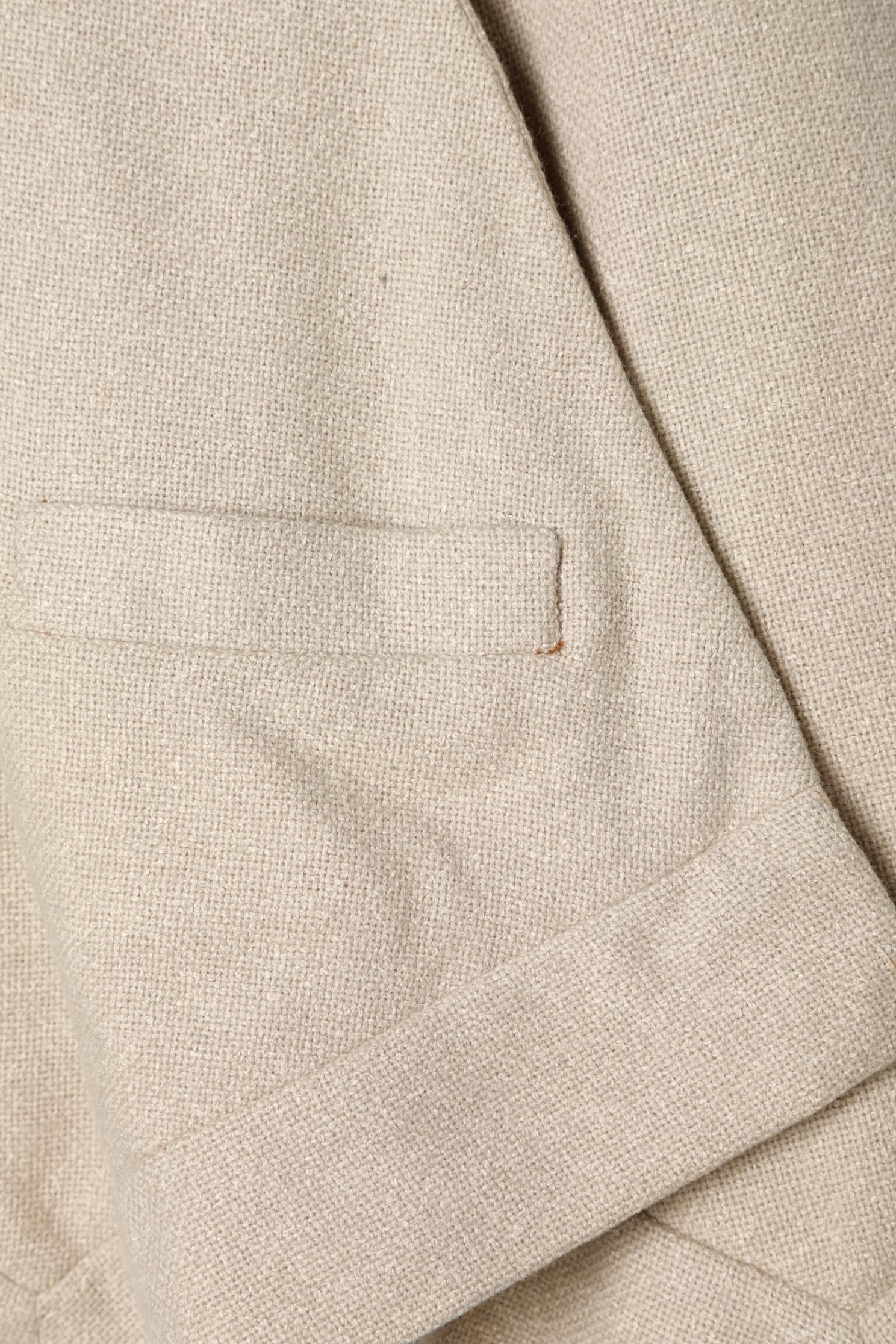 Cape courte en laine beige avec poche et trou pour les bras. Doublure en crêpe. 
Longueur totale de l'avant = 56 cm
Longueur totale du dos = 77 cm
TAILLE M 
