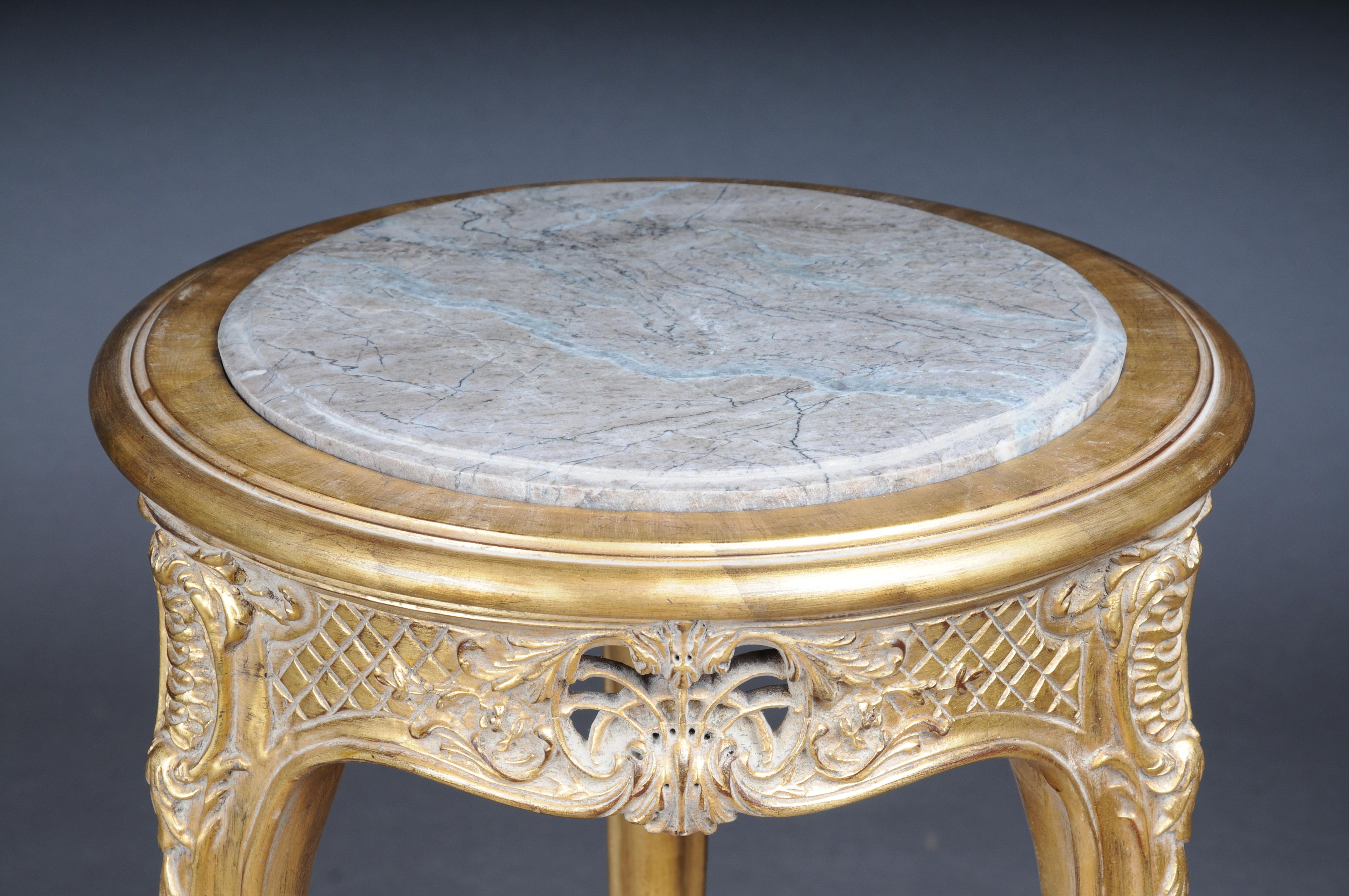 Finely carved gold side table with marble top, Louis XV

Excellent French Louis XV style table.
High-quality, solid beech wood, carved down to the smallest detail. Extremely decorative and noble. Round inserted and profiled marble slab which is