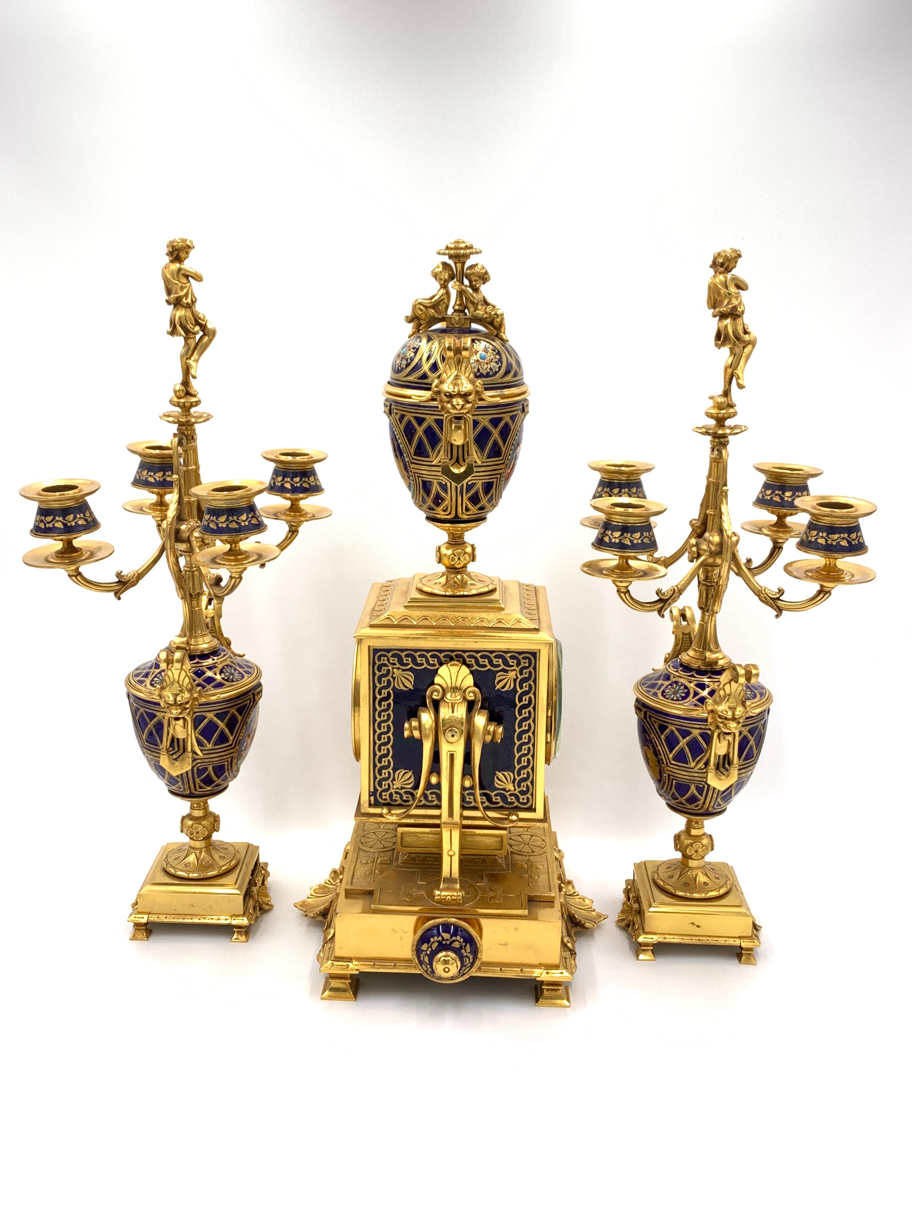 A fine quality 19th century French Sevres porcelain style and gilded ormolu clock garniture, impressive pair of four branch candelabra. 

Measures: Clock, H: 53cm, D: 24cm, W: 27cm
Candelabra, H: 50.5cm, D: 16, W: 20cm.