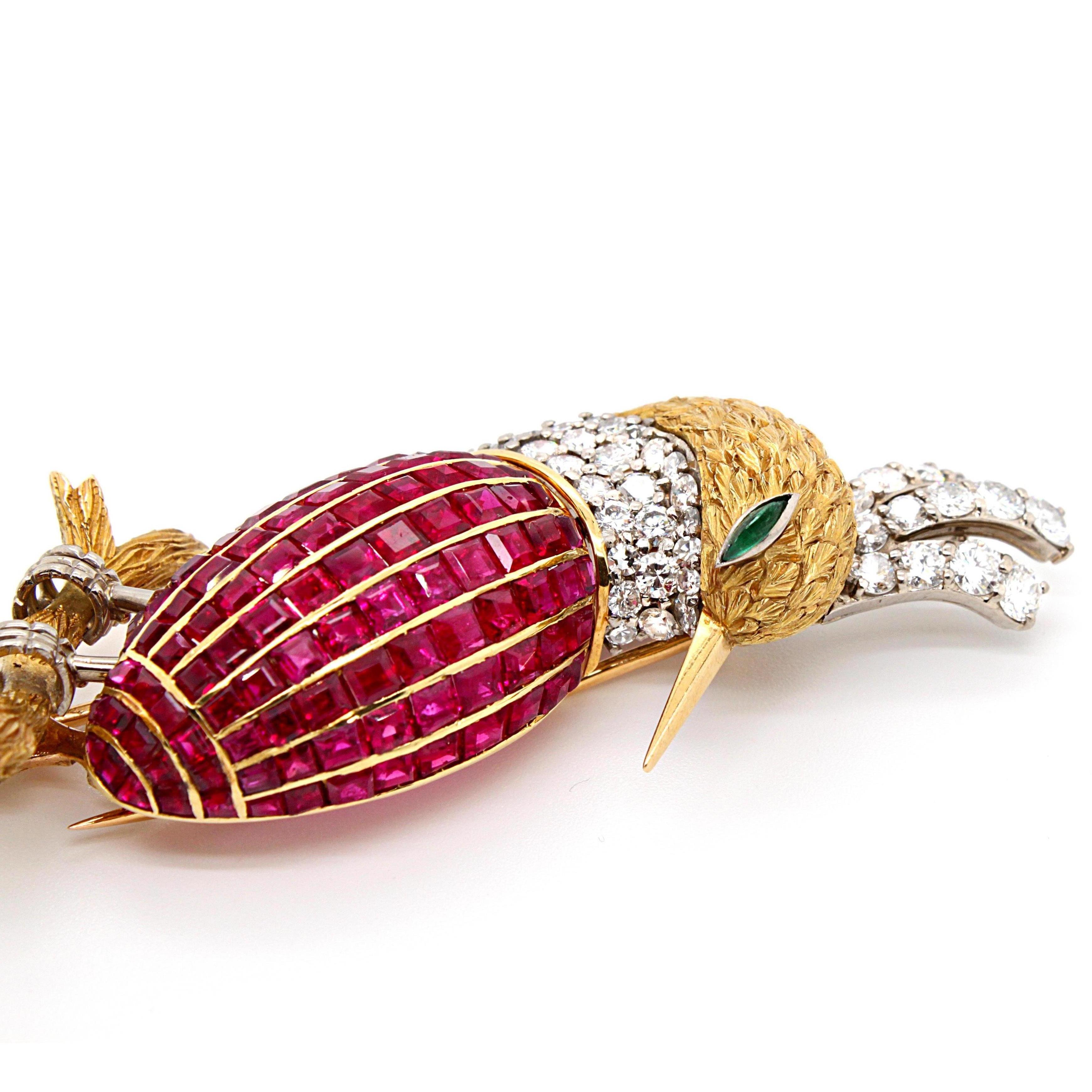 A ruby, emerald and diamond bird of paradise brooch in 18k yellow and white gold, France, ca. 1960s. 

The bird has a beautifully striking and strong design. It's crown, feathers and neck are set with round brilliant cut diamonds as well as ruby