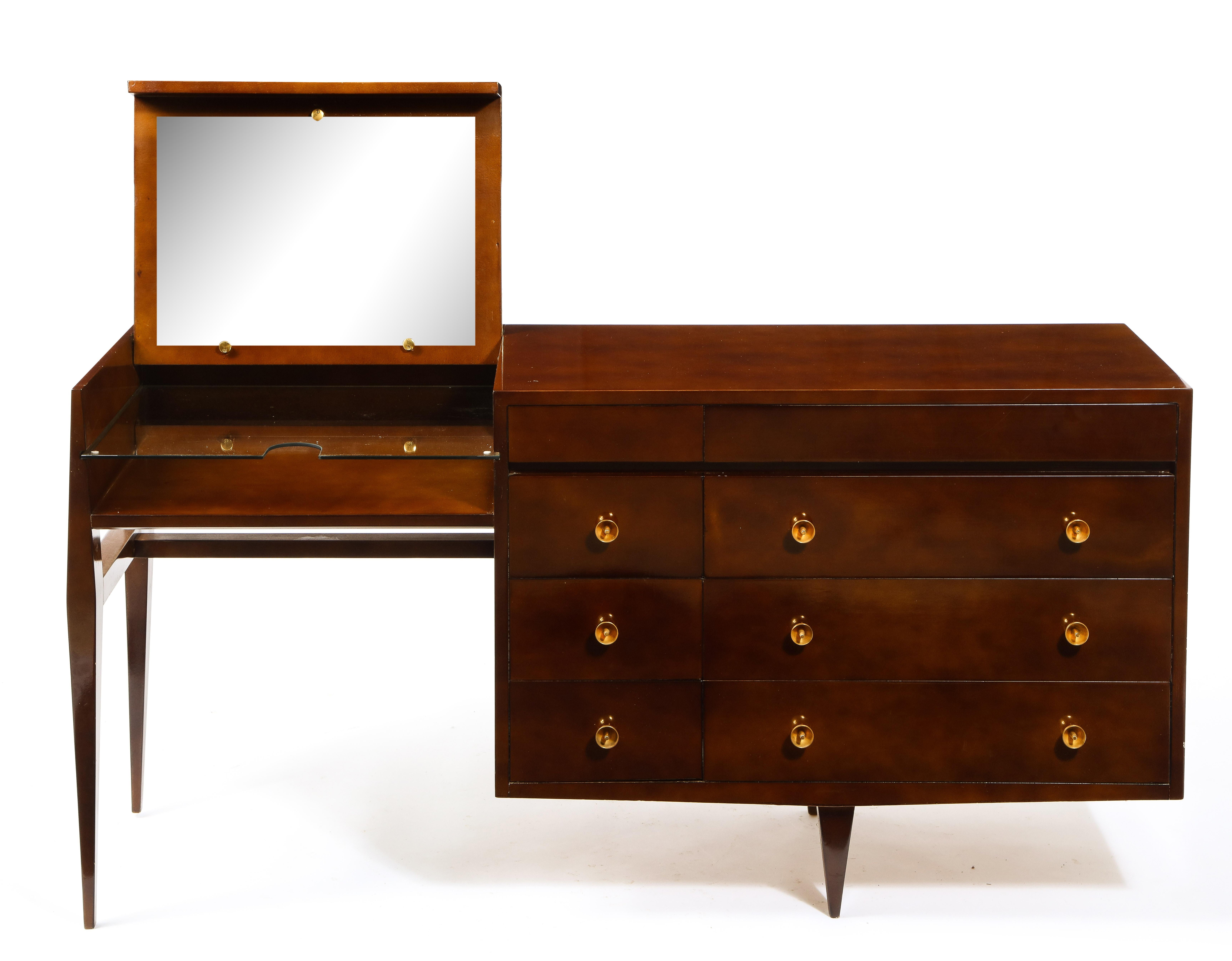 Elegant vanity by Raphael. A concealed mirror, and an abundance of drawers make this piece a convenient item. Original gilt bronze hardware and lacquer. Signed on a plate inside a drawer.