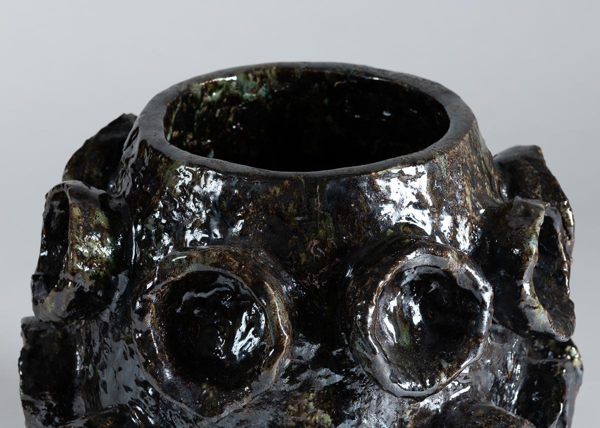 This beautiful contemporary Belgian vase's exterior takes its form from tentacles -- though blown up into a grand size, and fired in a dark, otherworldly glaze.