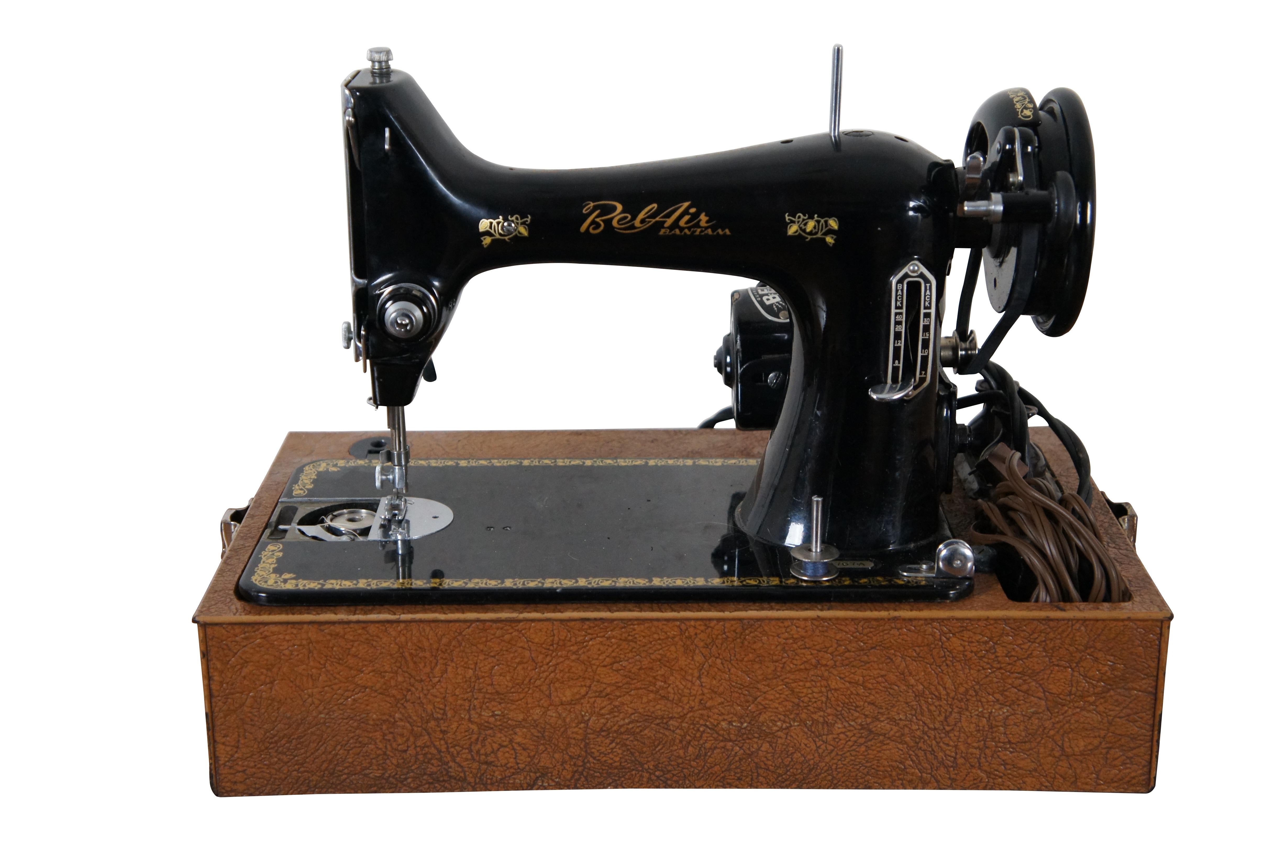 Mid century Bel-Air Bantam electric sewing machine and case. Black metal body with gold painted accents. Made in Japan. Serial number B509767A. Features Bell Electric Universal Motor, power cords, foot pedal, and box containing six assorted Singer