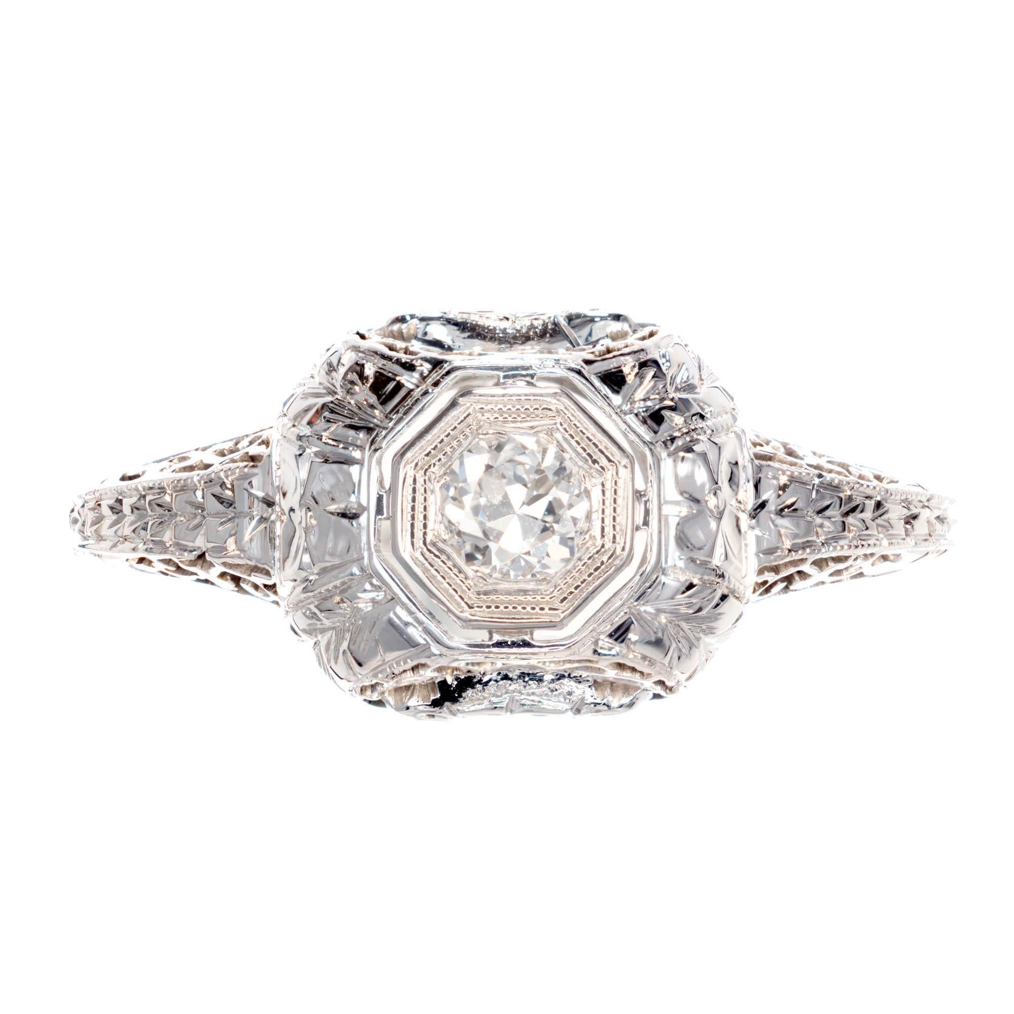 Belais diamond engagement ring. 18k white gold original Art Deco circa 1920s with highly detailed engraving and pierced filigree work. The center is set with an original transitional European cut sparkly Diamond.

1 round Diamond, approx. total