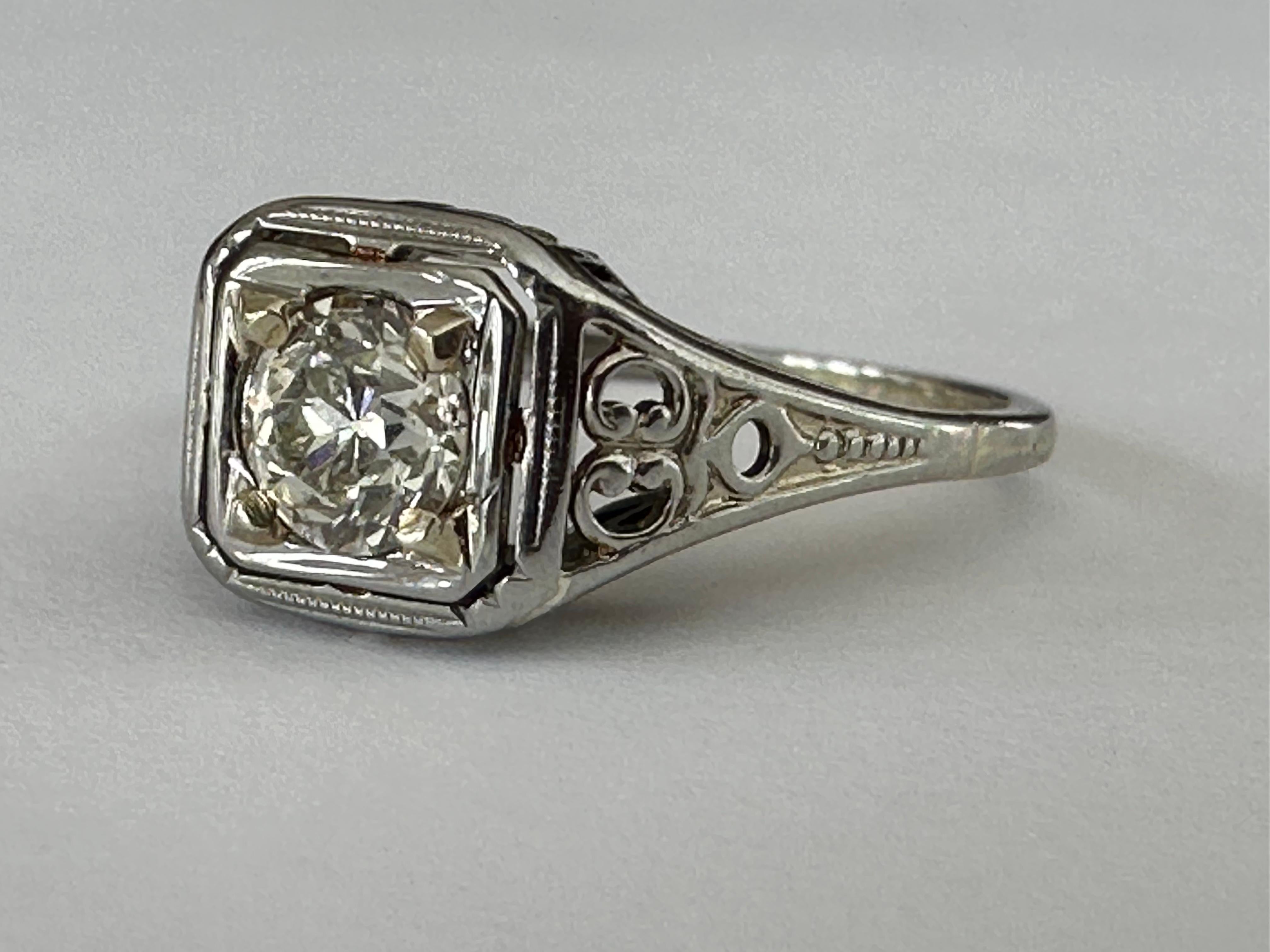 This stunning solitaire ring crafted in 18kt white gold from Belais Manufacturing Co in New York City, one of the first manufacturers of white gold in the United States, is designed around an Old European cut diamond center stone measuring