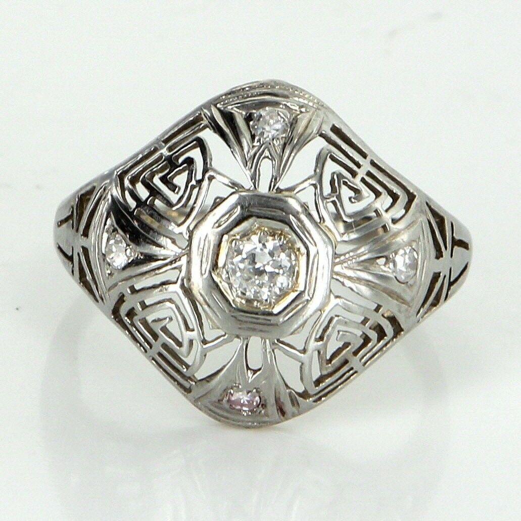 Vintage Belais Art Deco era cocktail ring (circa 1920s to 1930s) crafted in 18 karat white gold.

Old European cut diamonds total an estimated 0.23 carats (estimated at H color and SI1-2 clarity).

Belais Brothers is a highly regarded and very