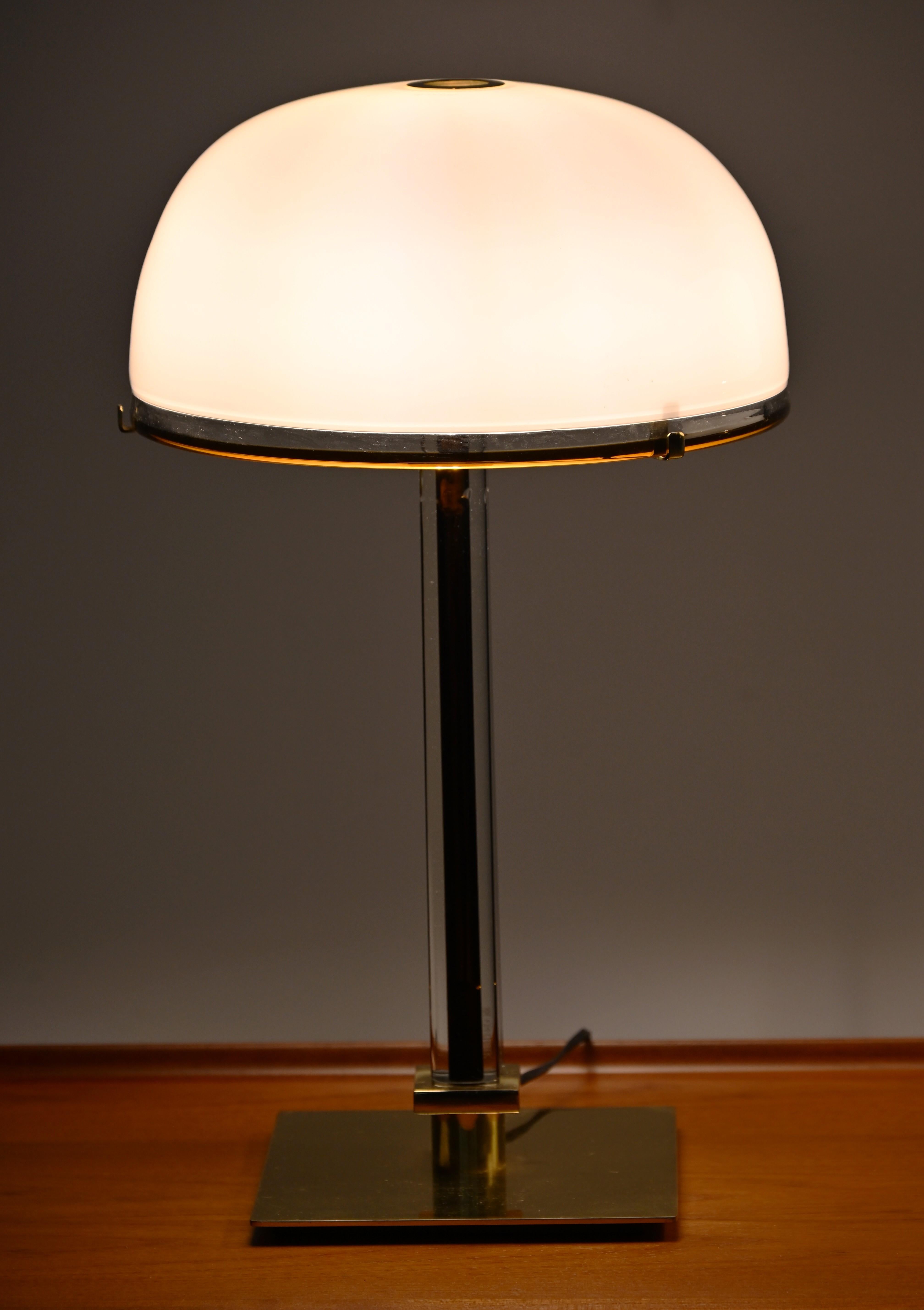 Ce design-Light italien du milieu du siècle, la lampe de table Belboi, a été créé par Venini en 1986. L'abat-jour en forme de dôme est soufflé à la main en couches de verre de Murano opaque blanc lait, produisant une lueur douce et diffuse lorsqu'il