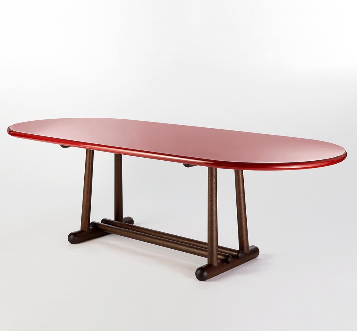 Belenus dining table by Gisbert Pöppler
Dimensions: D 240 x W 101 x H 73 cm
Materials: High gloss lacquered wood, smoked oak
La Luna extension side table also available.

The Belenus table stands on solid rounded legs and connecting oval shaped feet