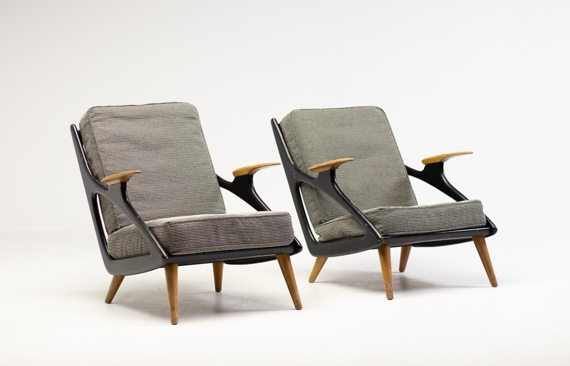 Pair of arm chairs made in Belgium, circa 1950.
Great 1950's design reminiscent of the designs by Jean Prouvé of the same era.
High quality construction of a maple frame that is partially lacquered black, and steel spring cushions.
The upholstery