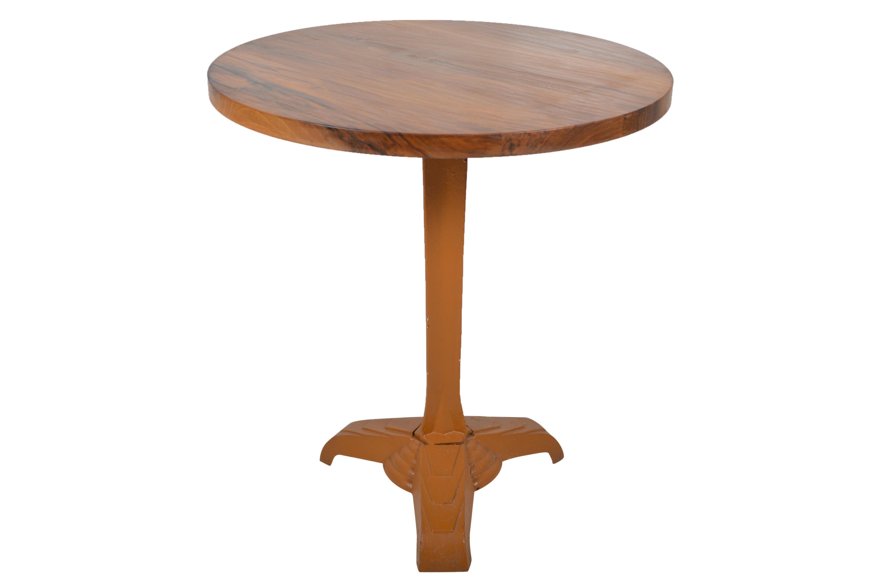 Wonderful ochre painted Art Deco cast iron bistro table base with well figured walnut top. Tripod leg with fan shaped decorations.