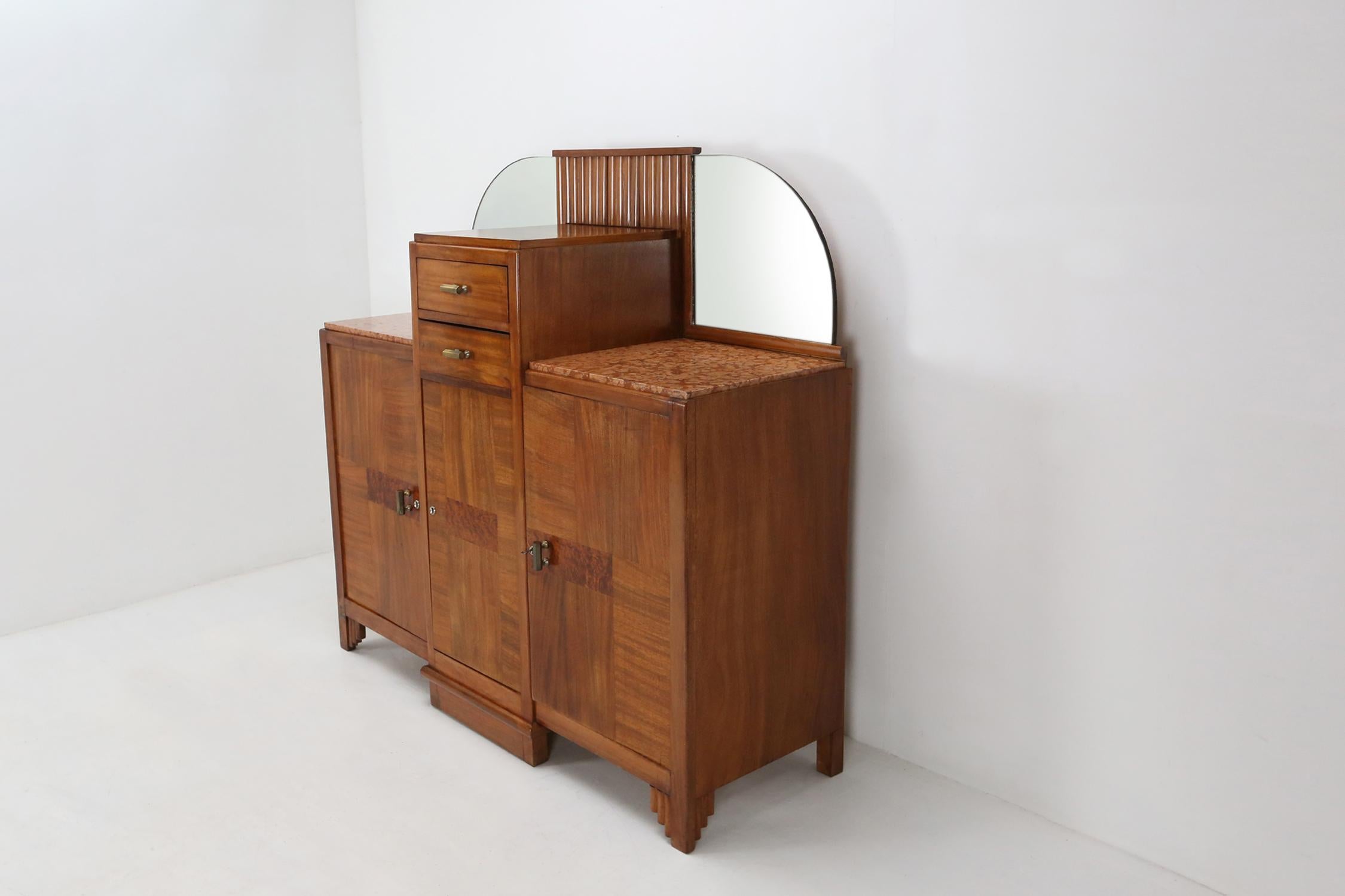 Belgian Art Deco cabinet made around 1930.
Has some great geometric details. Mirrors on two sides and a marble top.