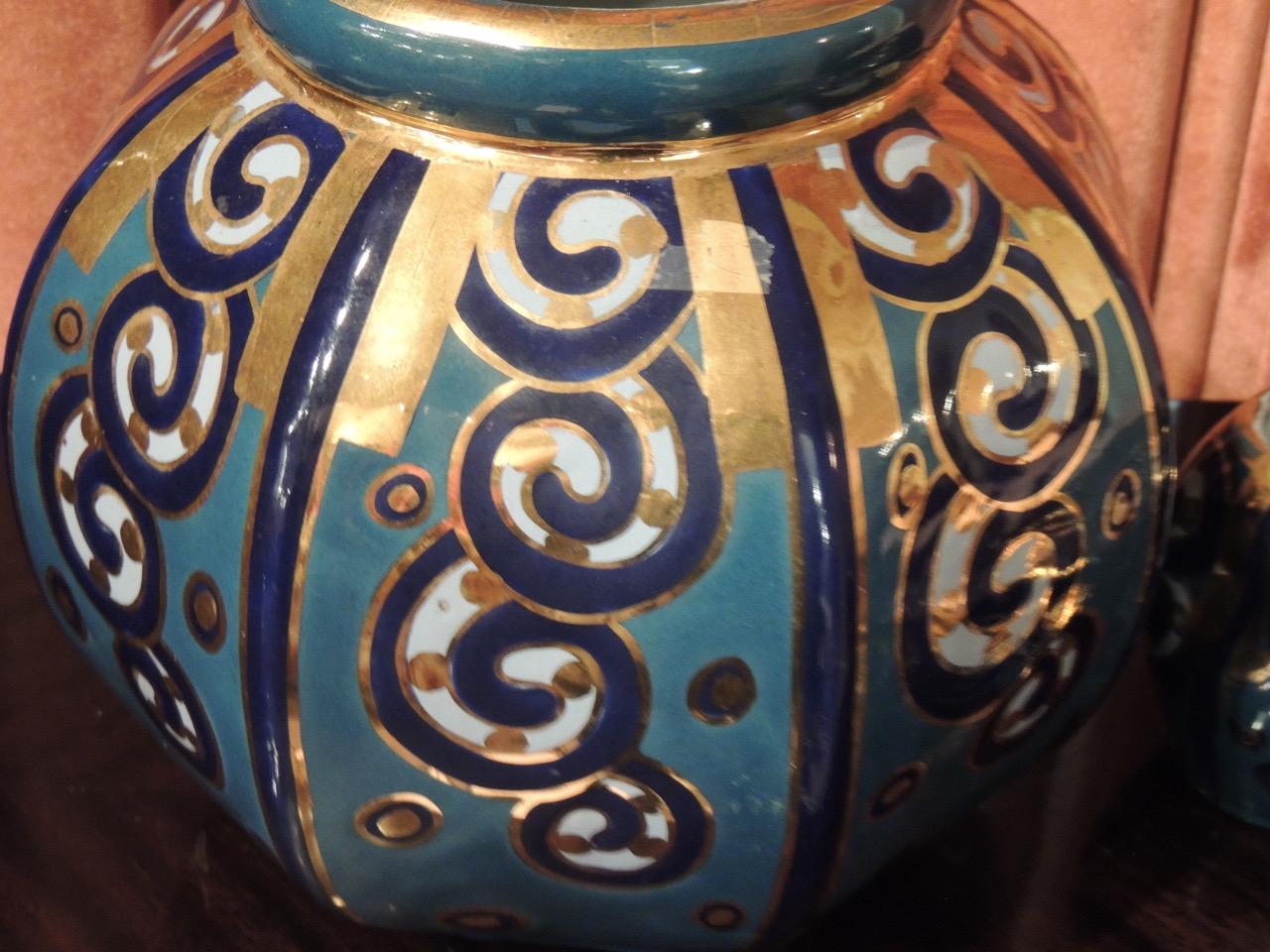 Art Deco Ceramics from Cerabelga of Belgium with an interplay of gilding and stylized scrolls in turquoise and cobalt blue glazing. Cerabelga produced these pieces in the late 1920s, contributing to the legacy of Belgian pottery that was the epitome