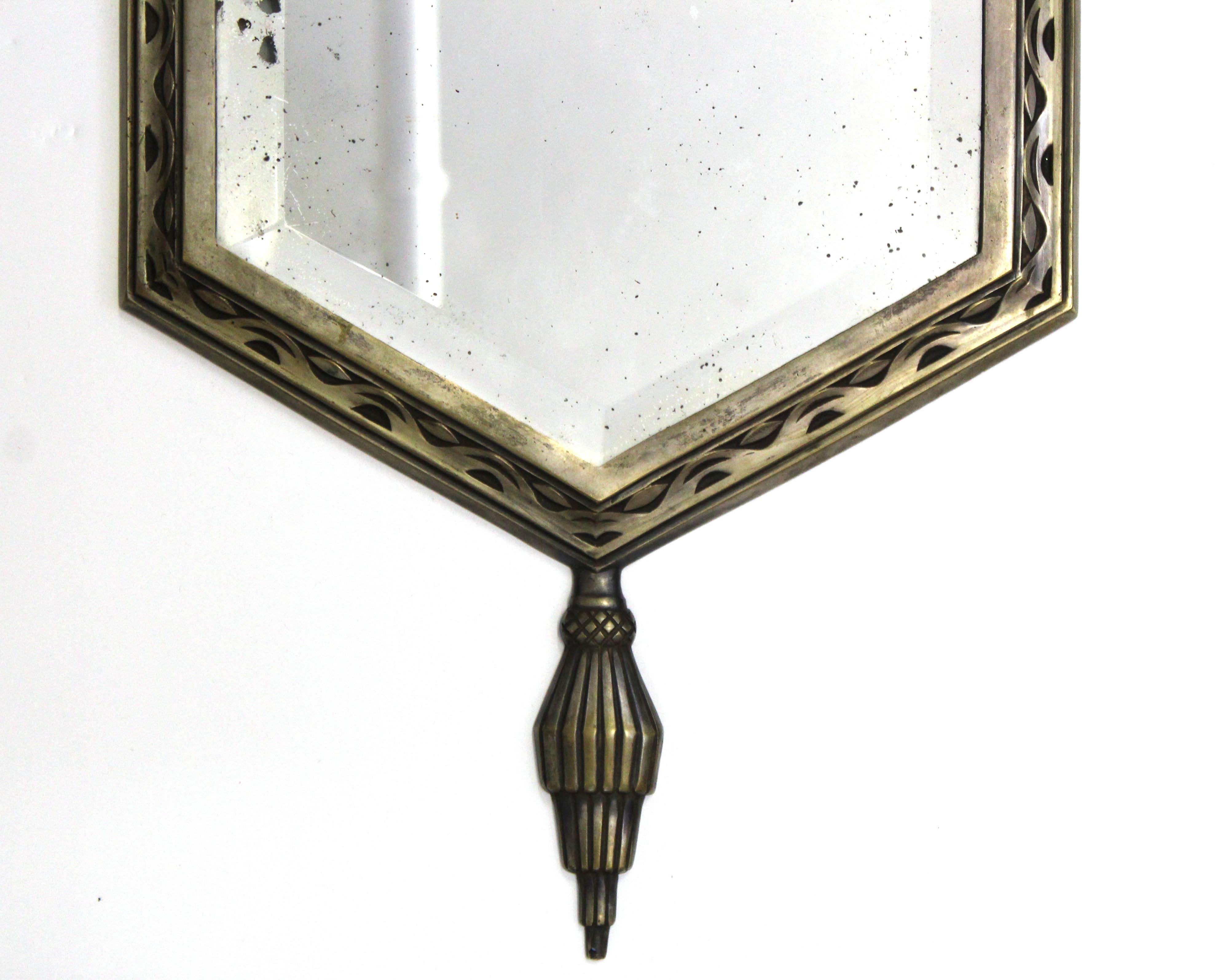 Belgian Art Deco diminutive wall mirror with original double-beveled hexagonal mirror inserted into nickel over bronze frame. The piece was made in Belgium in the 1920s and is in great antique condition with age-appropriate wear and use. 'Made in