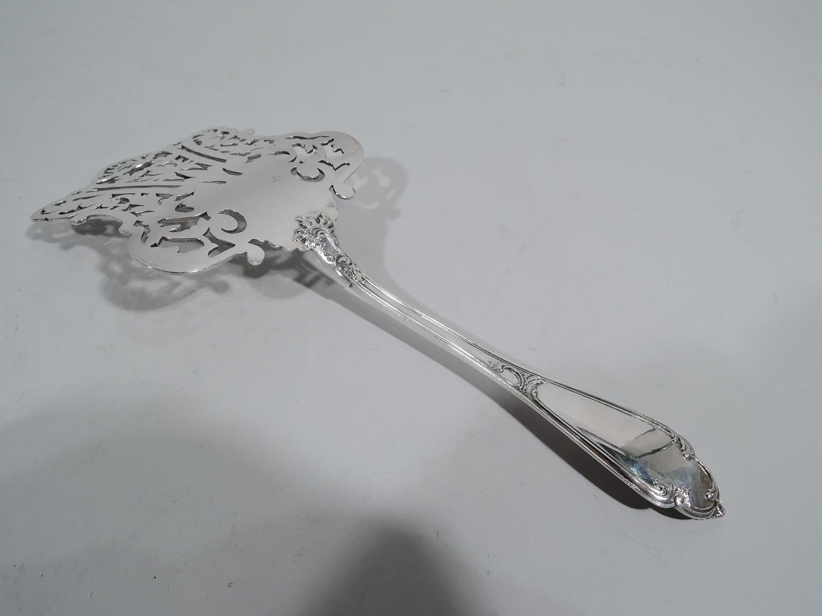 Turn-of-the-century Art Nouveau 800 silver asparagus server. Made by Wolfers Frères in Belgium. Shaped blade with engraved and open leaves and scrolls. Tapering handle with scrolled double-sided terminal (vacant). Fully marked. Weight: 5.5 troy