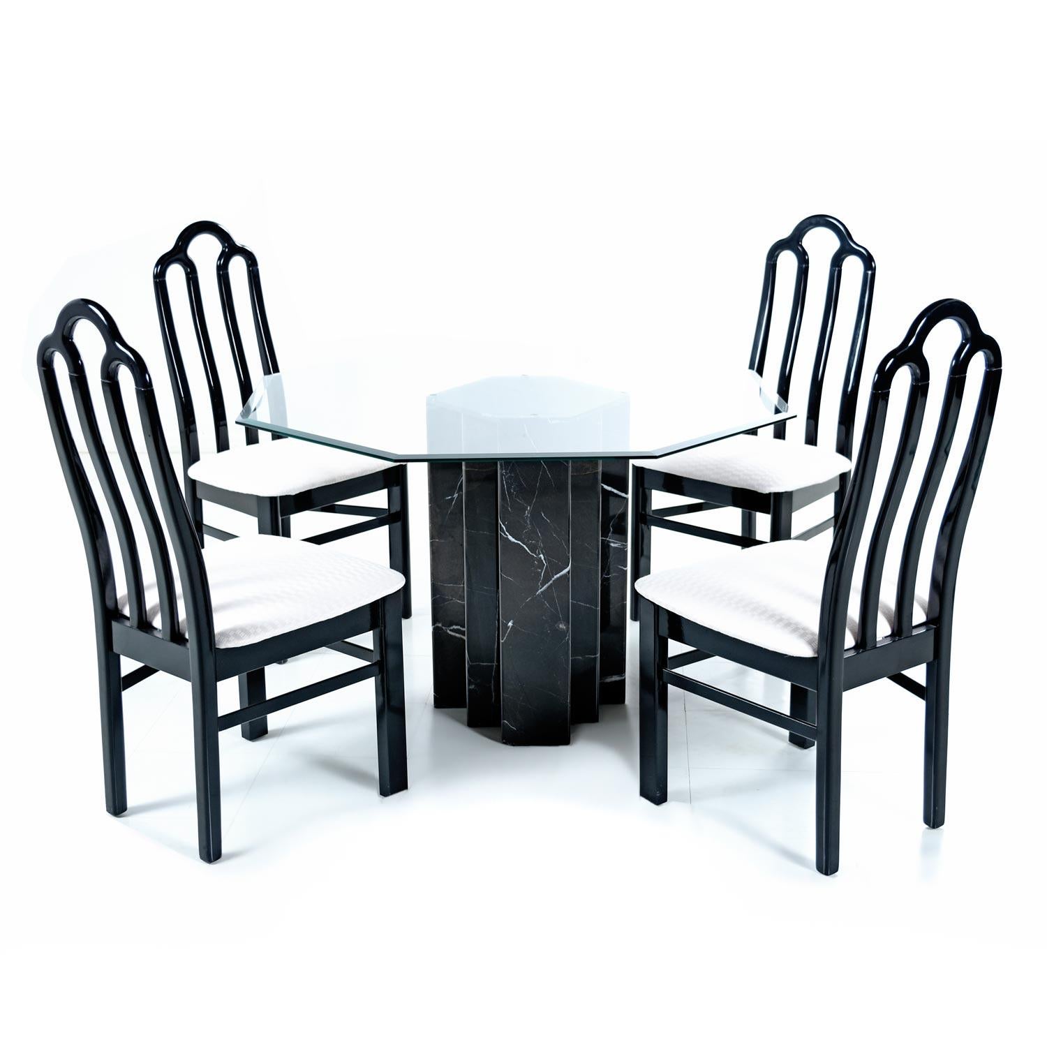 This handsome dining table has a regal presence with it’s stately, yet sexy, black marble base. The vintage 1980s dining set has resembles work by Carlo Scarpa. The sleek dining set comes complete, as pictured with a dining table and four chairs.