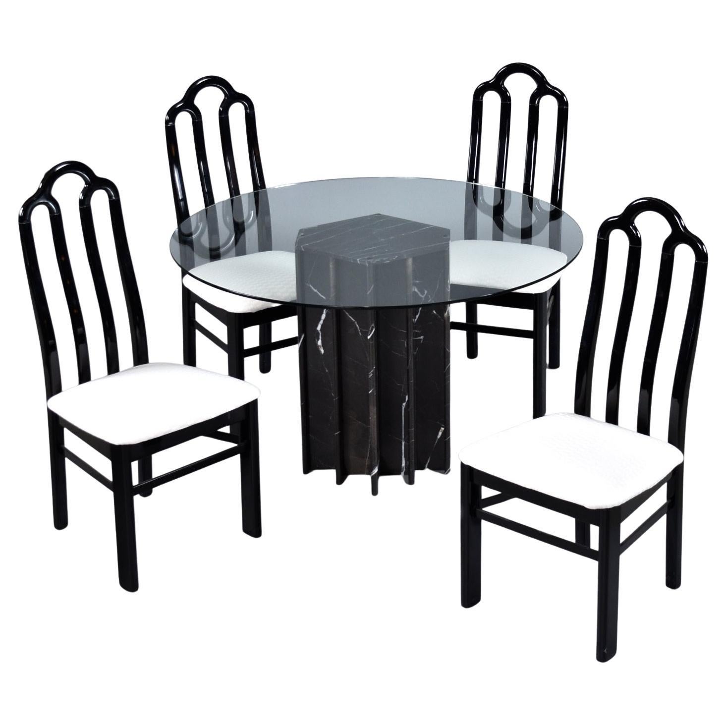Vintage 1980s black and white Neo Deco dining set. The luxurious black marble pedestal base features striking white veins and fields of mystical taupe-gray. It’s almost as if a thunderstorm was captured in stone. Dynamic white bands streak through
