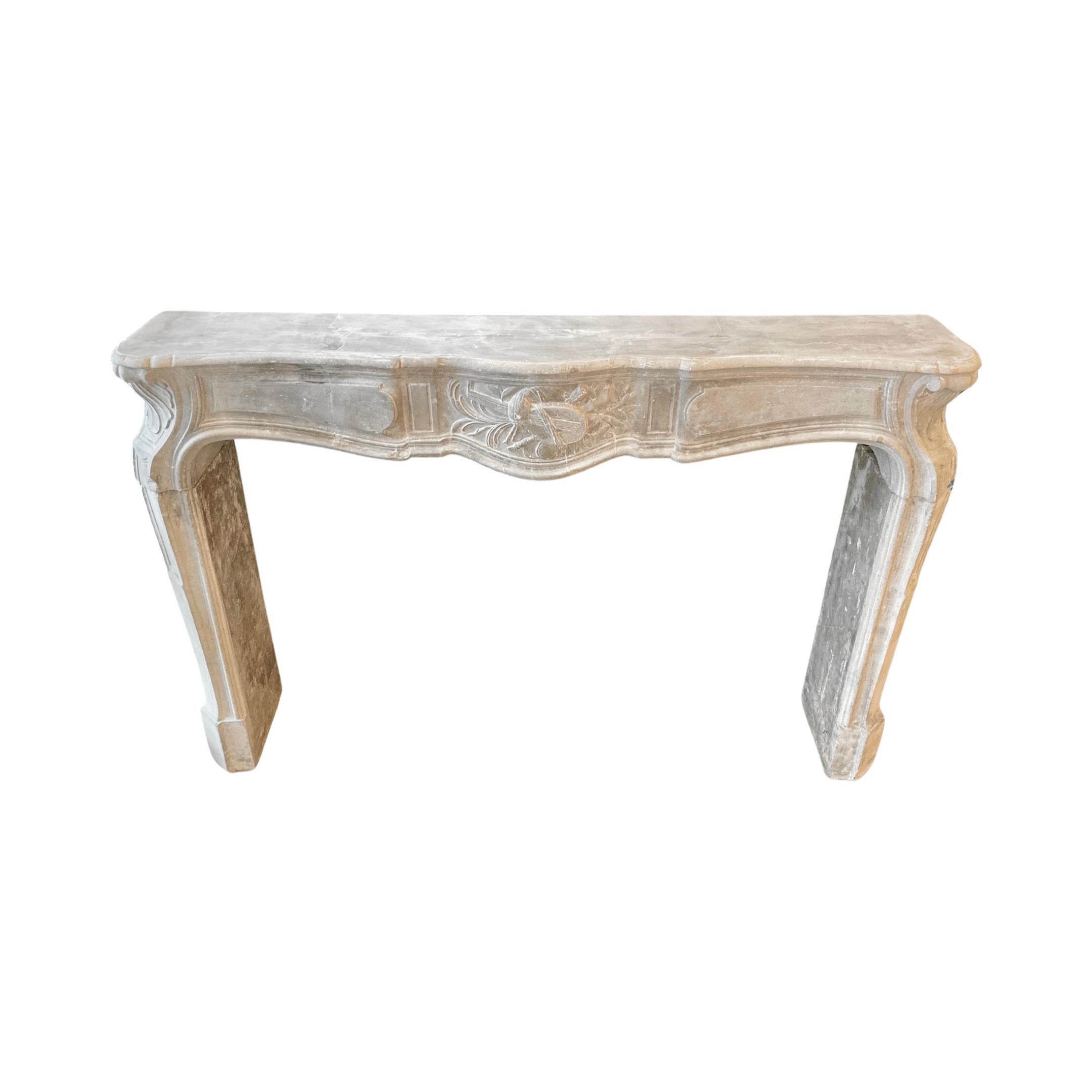 Expertly crafted in Belgium during the 18th century, our Belgian Bluestone Mantel features intricate carvings on the legs and a unique centerpiece with musical instrument motifs. Made from high-quality bluestone, this mantel adds elegance and