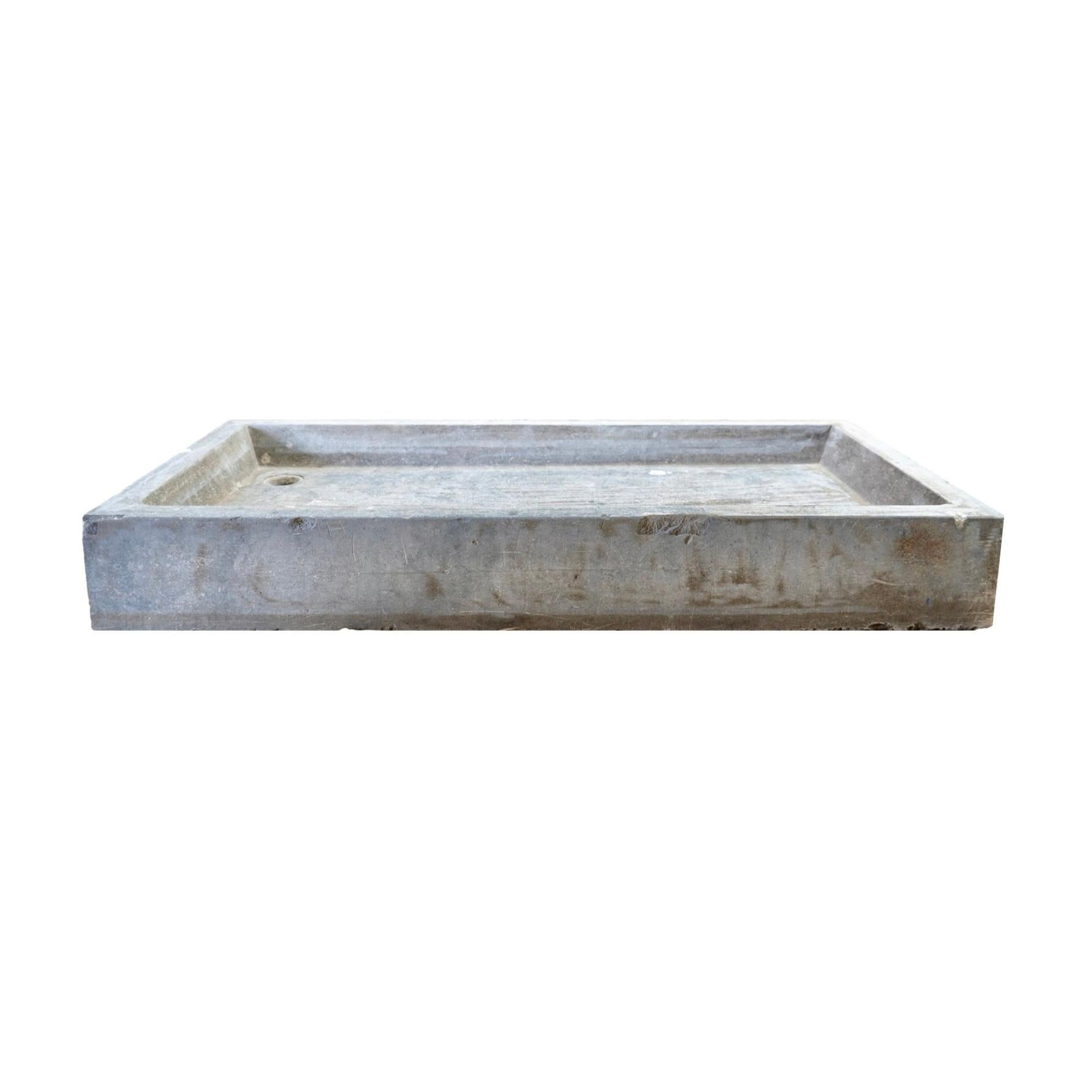 This Belgian Bluestone Sink is a timeless piece that brings both style and functionality to any kitchen or bathroom. Hand-crafted from reclaimed 1880's bluestone and imported from Belgium, this wide rectangular sink features a pre-drilled hole for