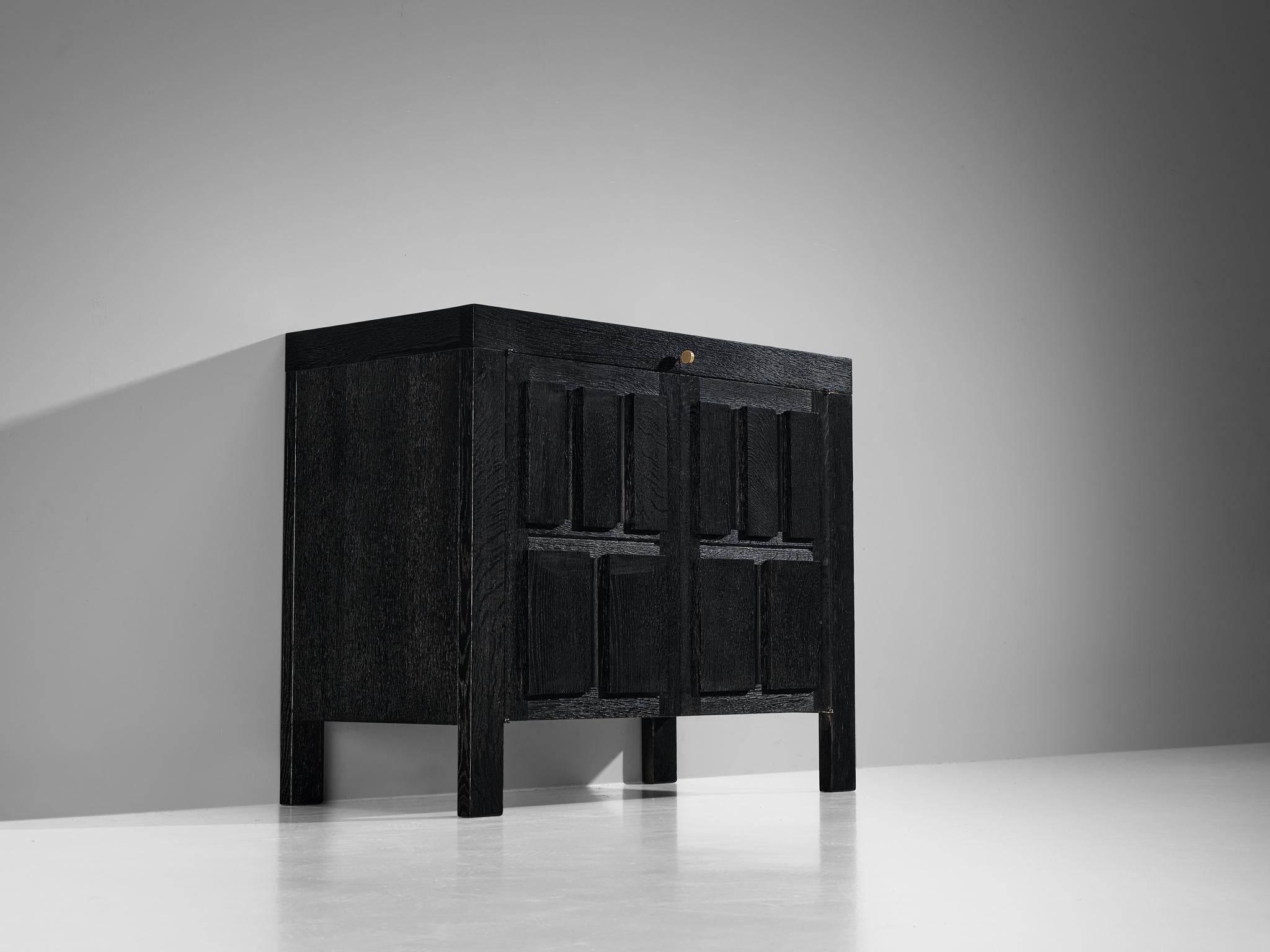 Cabinet, lacquered oak, brass, Belgium, 1970s

This Belgian sideboard features a clear rhythm and flow established by means of a well thought through lay out that is utterly well-balanced. The carved geometrical shapes on the door panels immediately