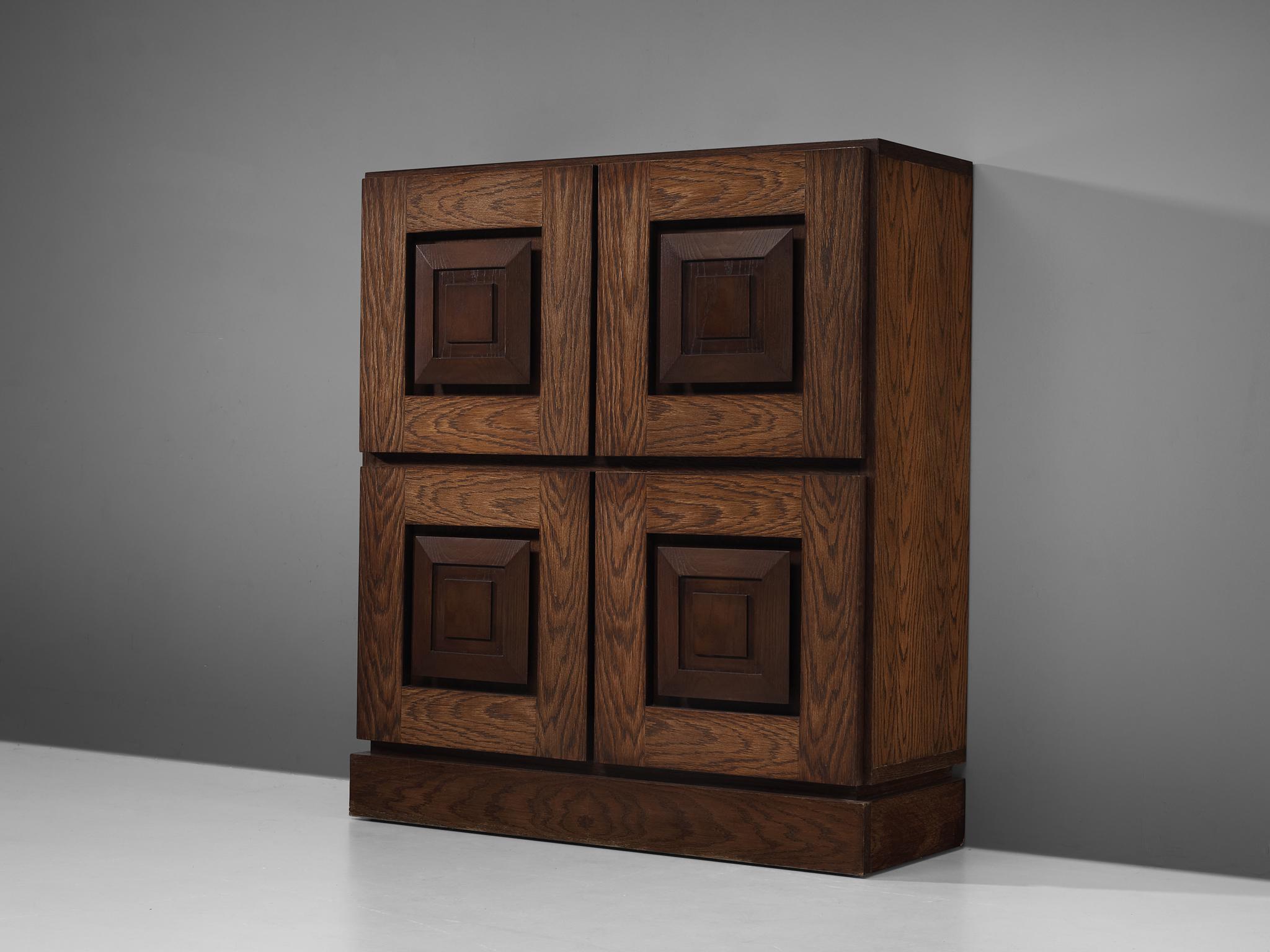 Cabinet, solid oak, Belgium, 1970s

This cabinet features a clear rhythm and flow established by means of a well thought through lay out that is utterly well-balanced. The carved square door panels immediately catch the eye and are the signature for