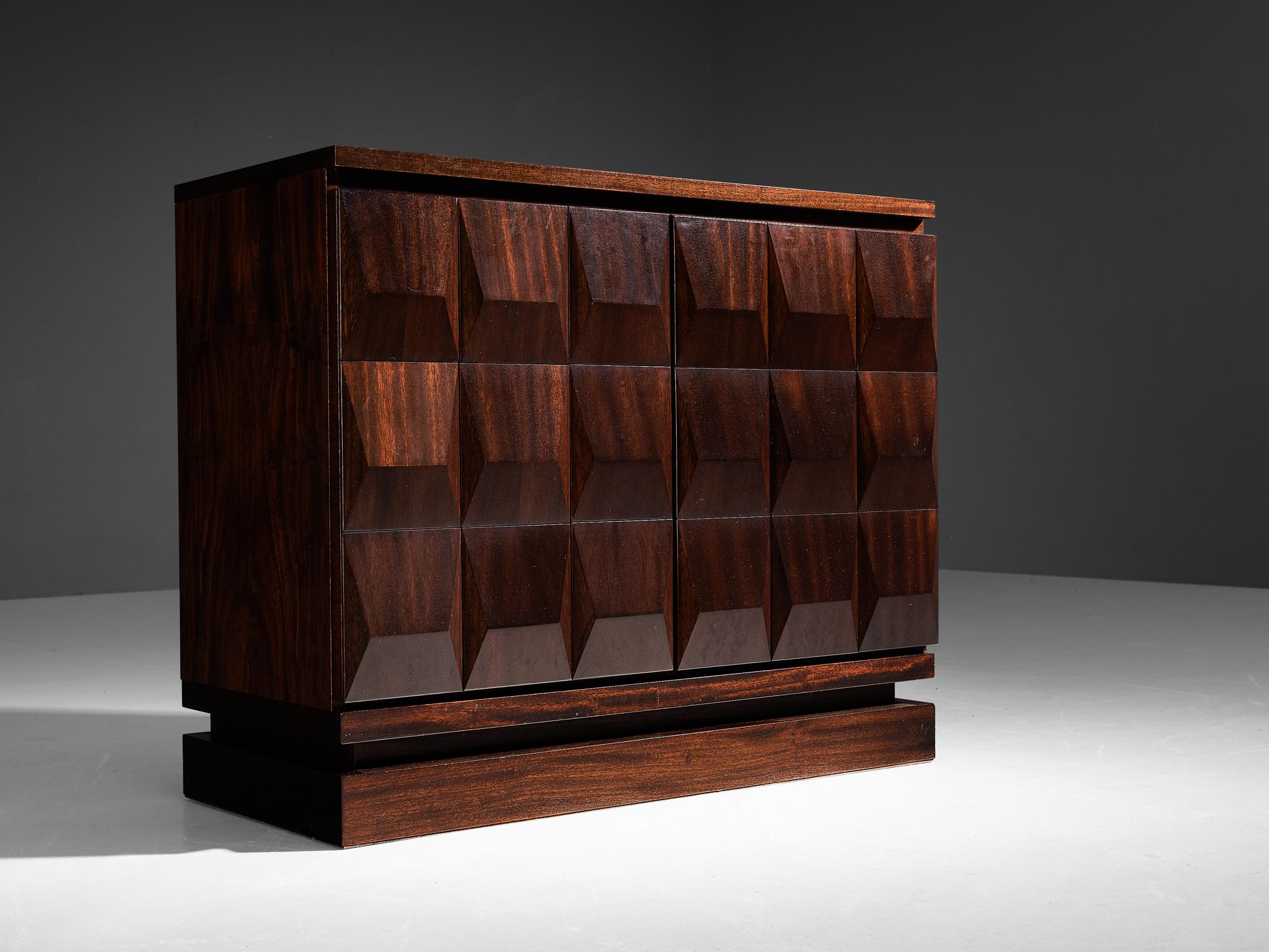 Cabinet, dark brown stained oak, Belgium, 1970s.

This very evocative cabinet features a clear rhythm and flow established by means of a well thought through lay out that is utterly well-balanced. The carved door panels  immediately catch the eye