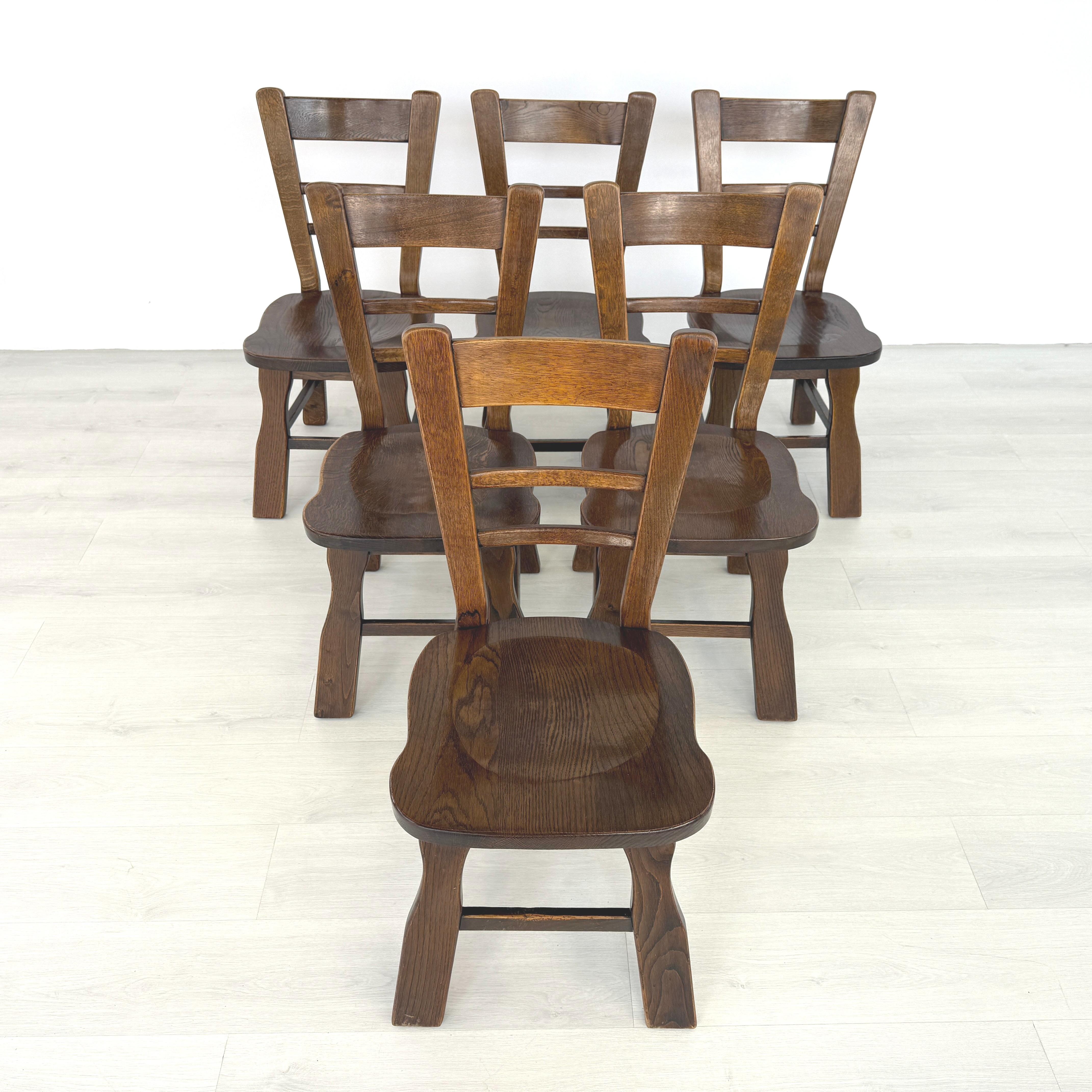 Dimensions: H 35” x W 17” x D 22” x SH 17.5”

Set of 6 Belgian Brutalist dining chairs. Massive oak back with three ladders across for great support and comfort. Vintage furniture is great for the environment, for your home and for your wallet.